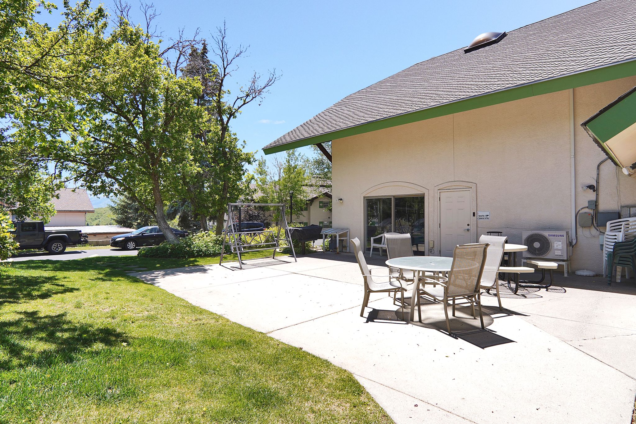 Expansive concrete patio area with sliding glass door access to the interior