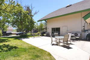 Expansive concrete patio area with sliding glass door access to the interior