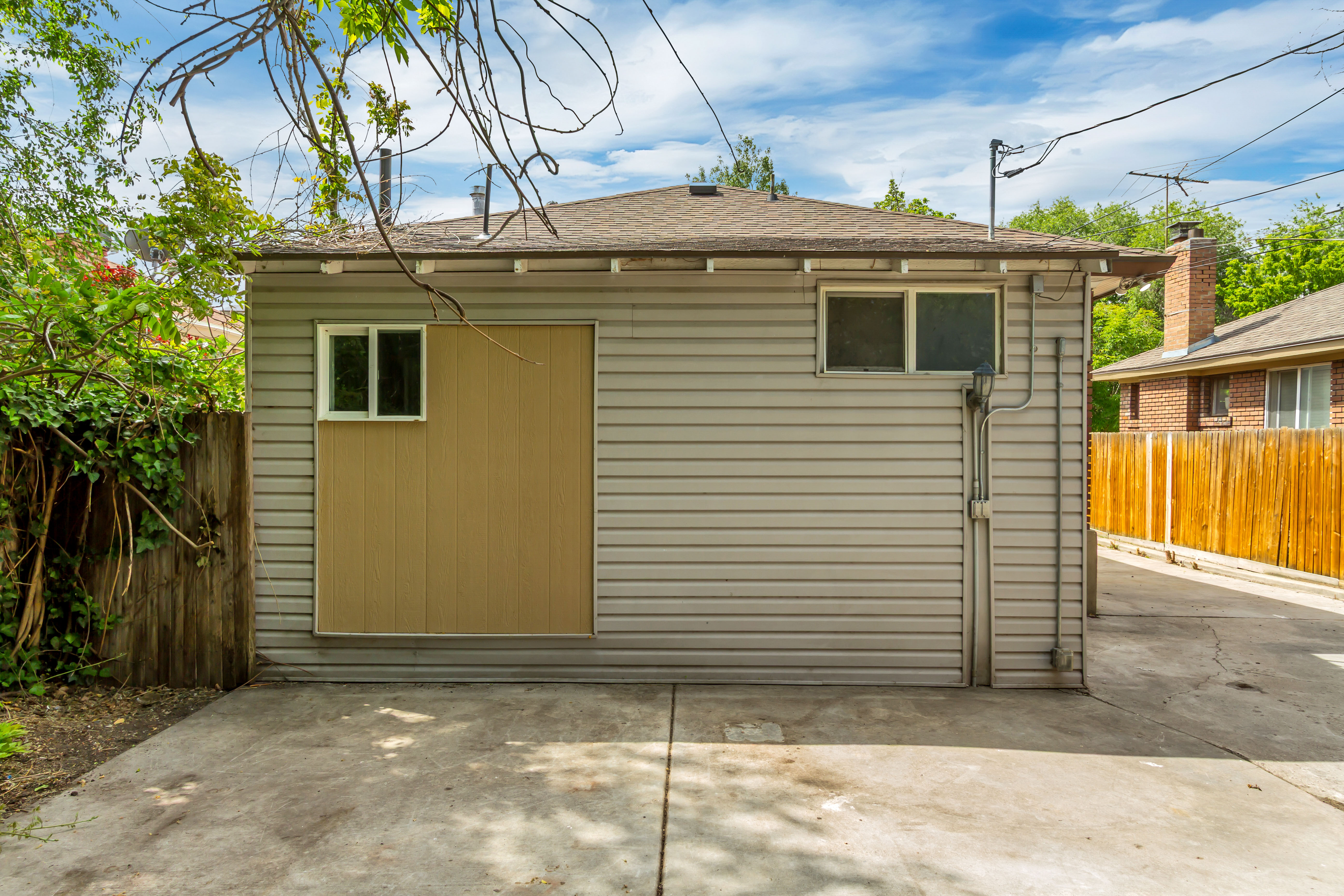 Detached garage featuring horizontal siding and a shingle roof