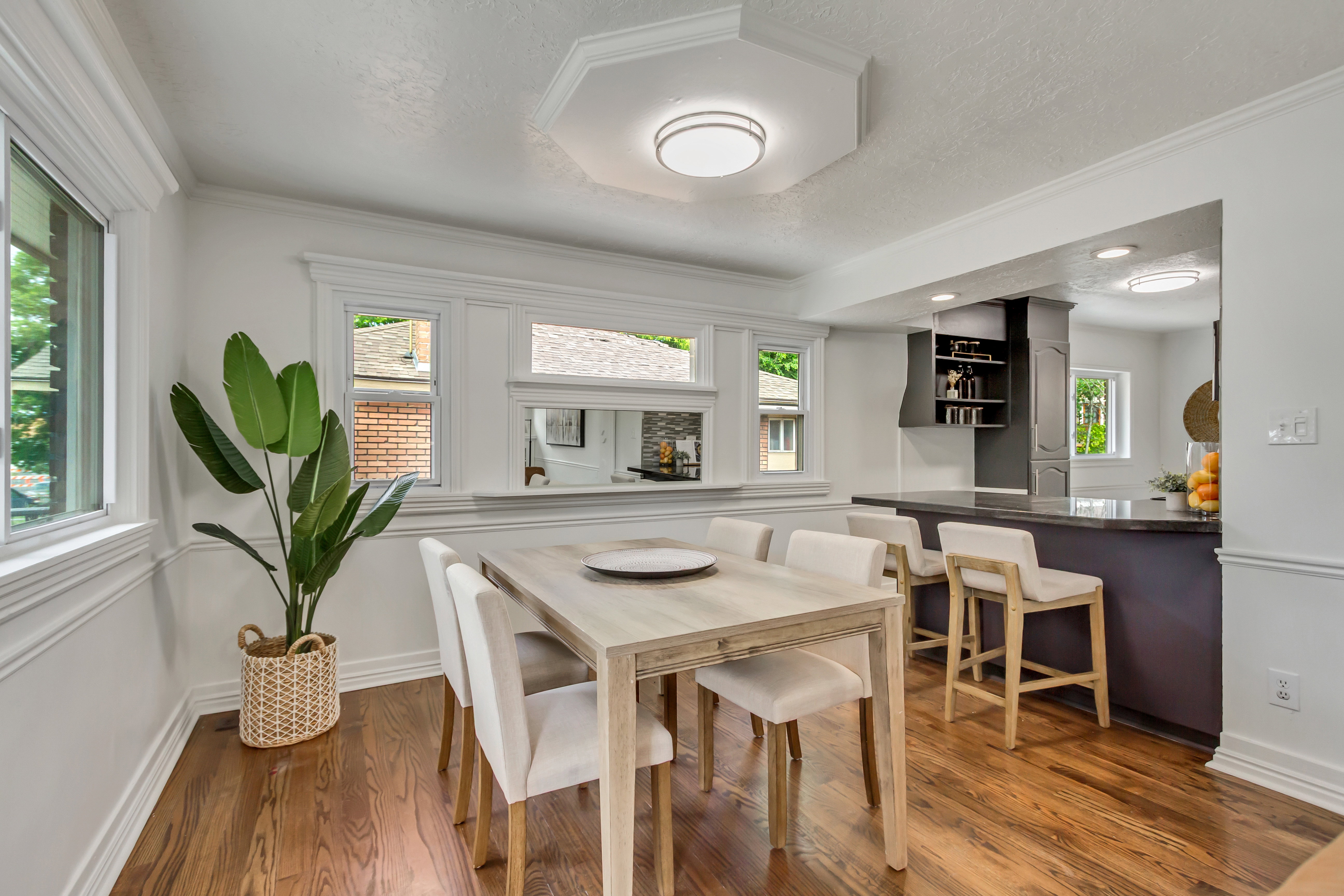Dining area with wood-finish flooring and extensive crown molding