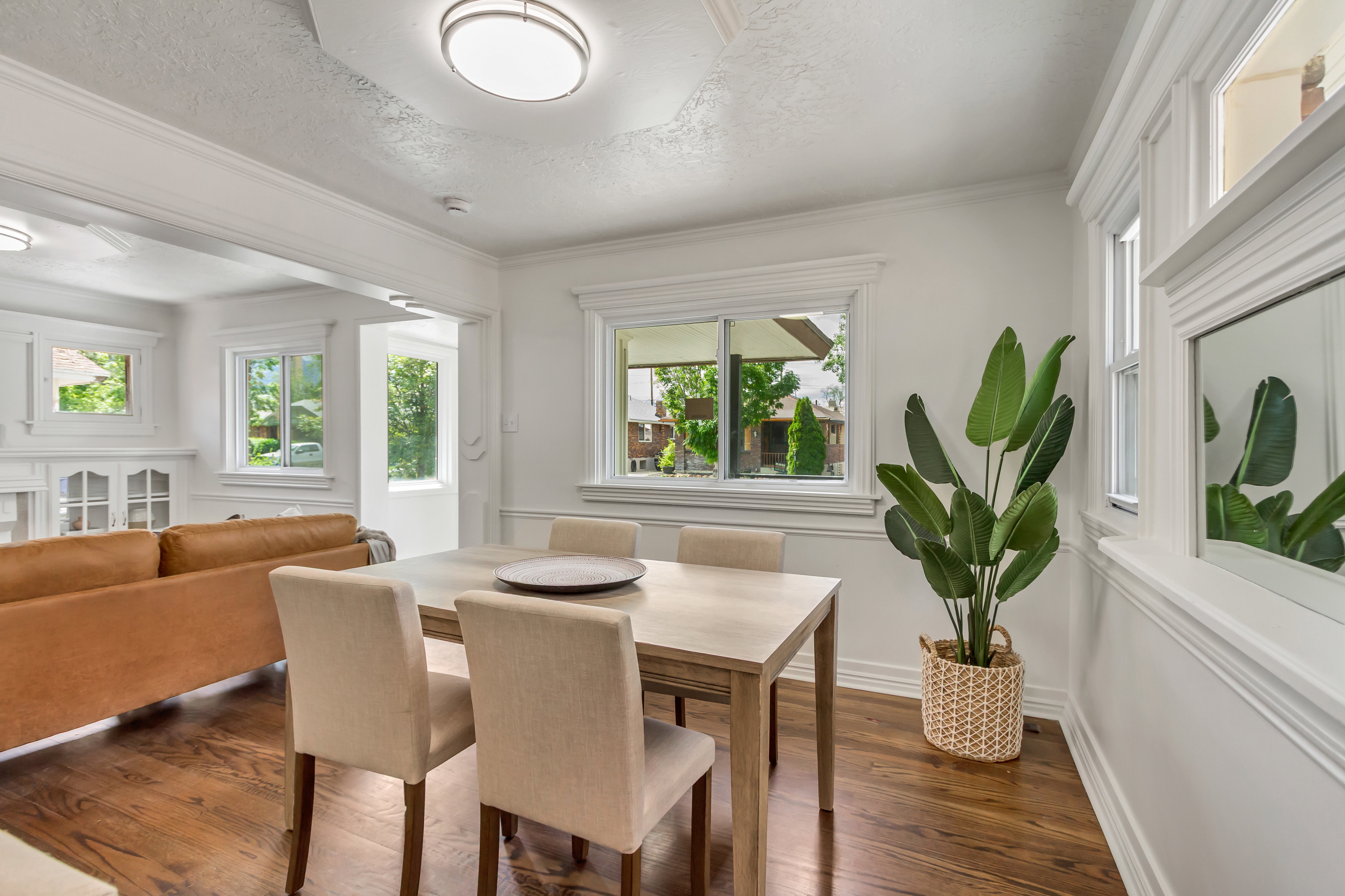 Hardwood flooring highlights this dining area featuring ample natural light from multiple windows