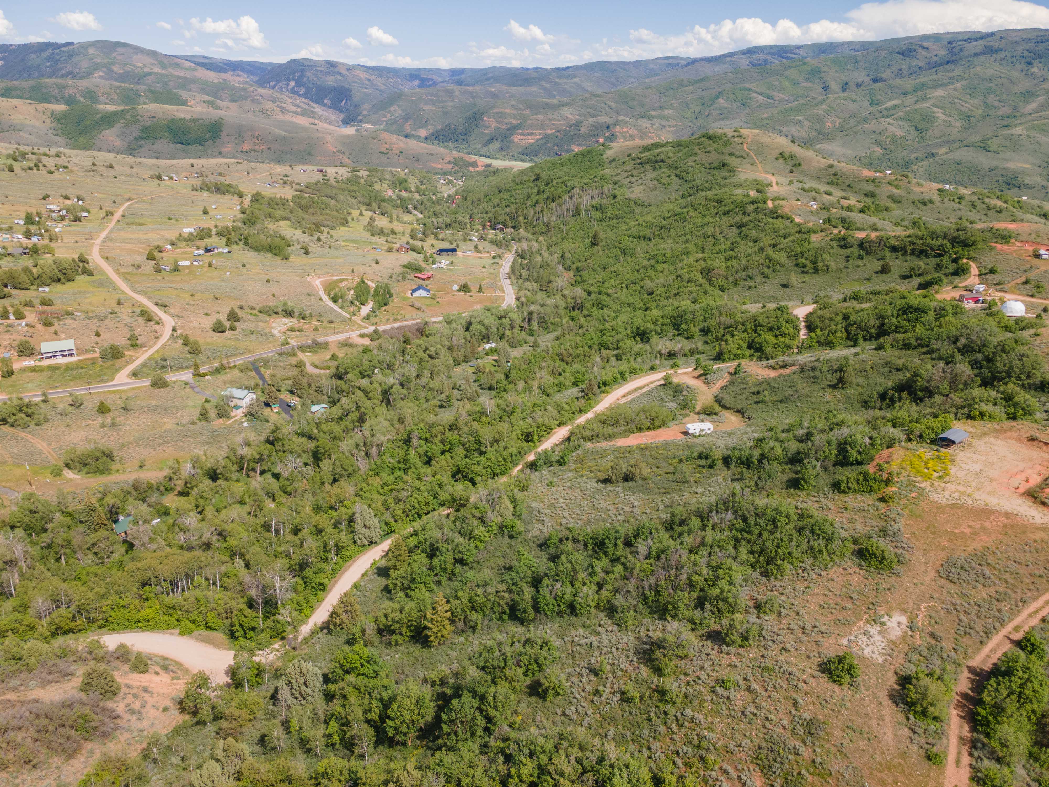 Expansive landscape featuring rolling hills and dense tree coverage
