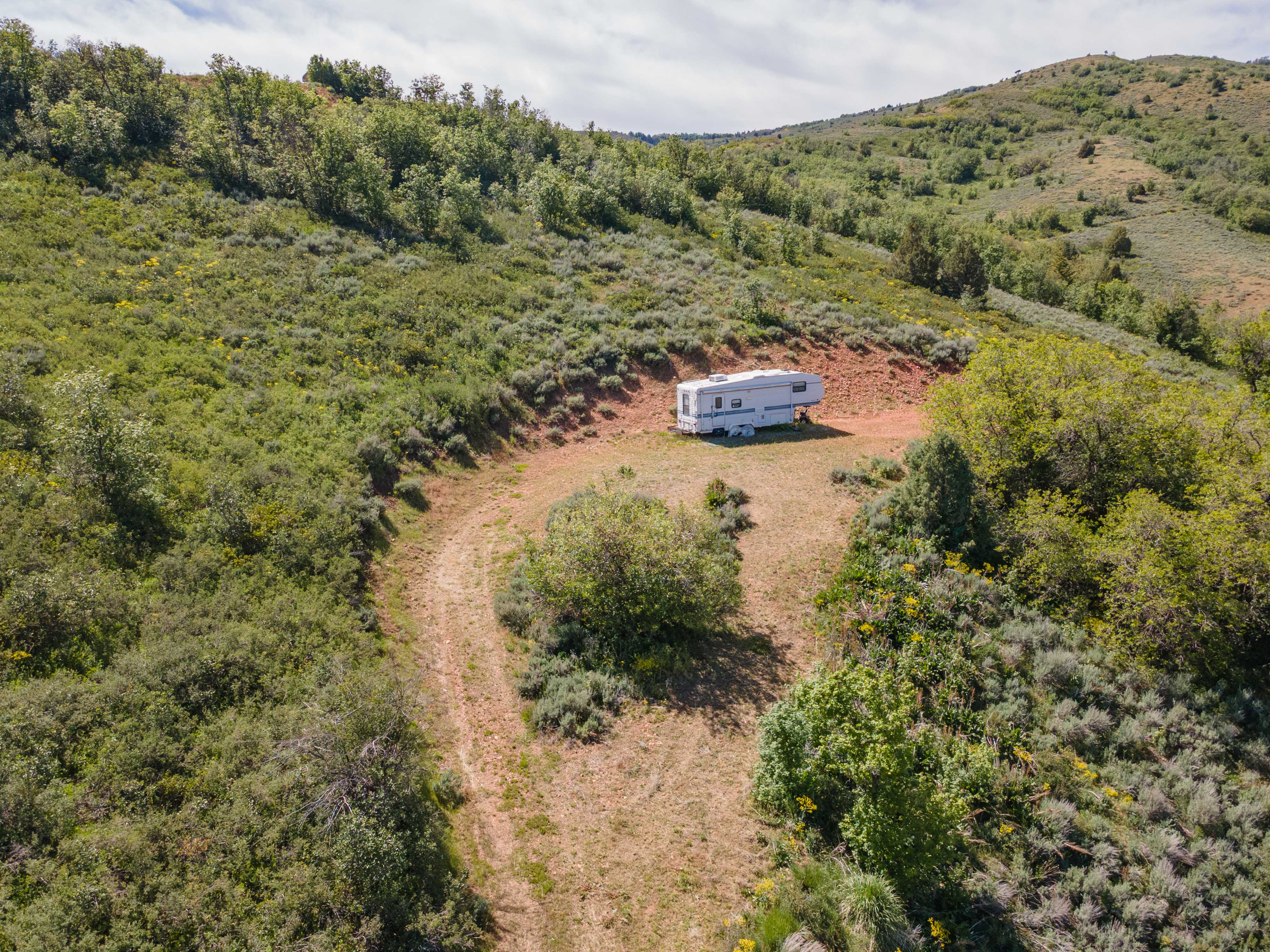 Expansive undeveloped land featuring rolling hills and varied vegetation