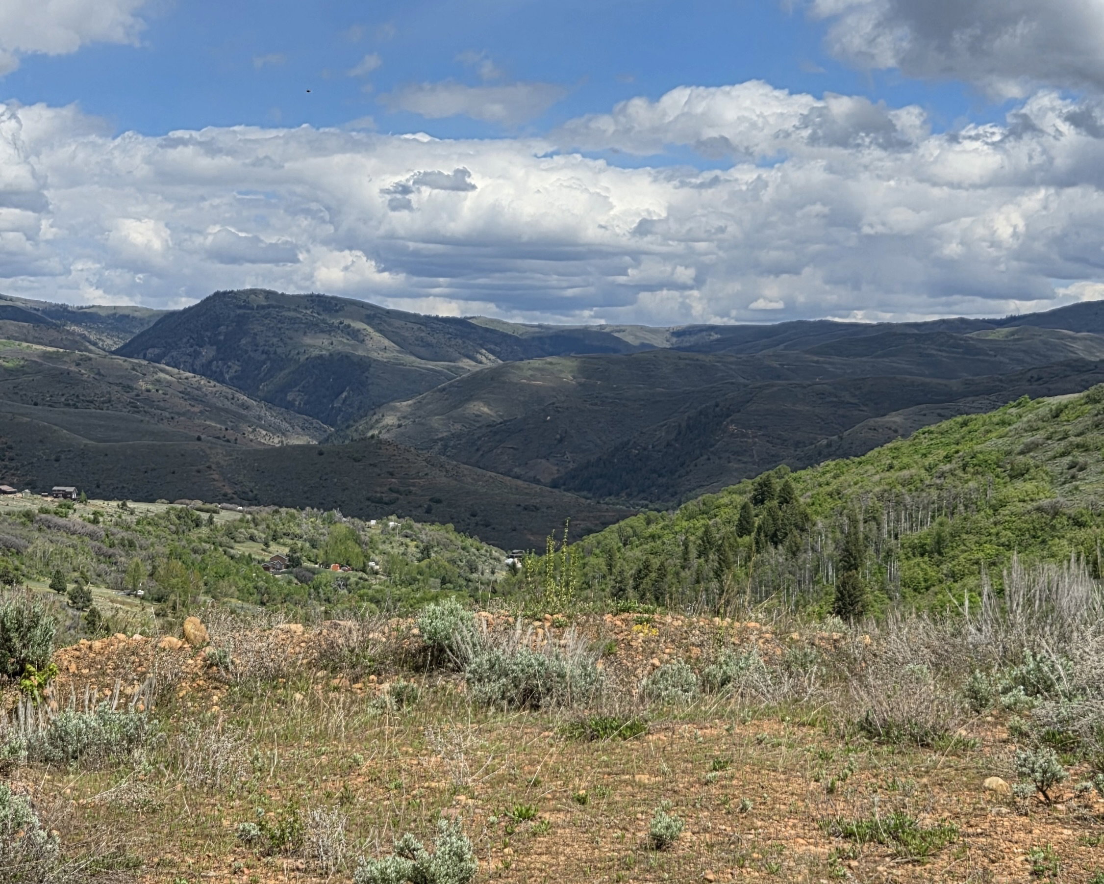 Expansive mountain landscape featuring varied terrain and distant peaks