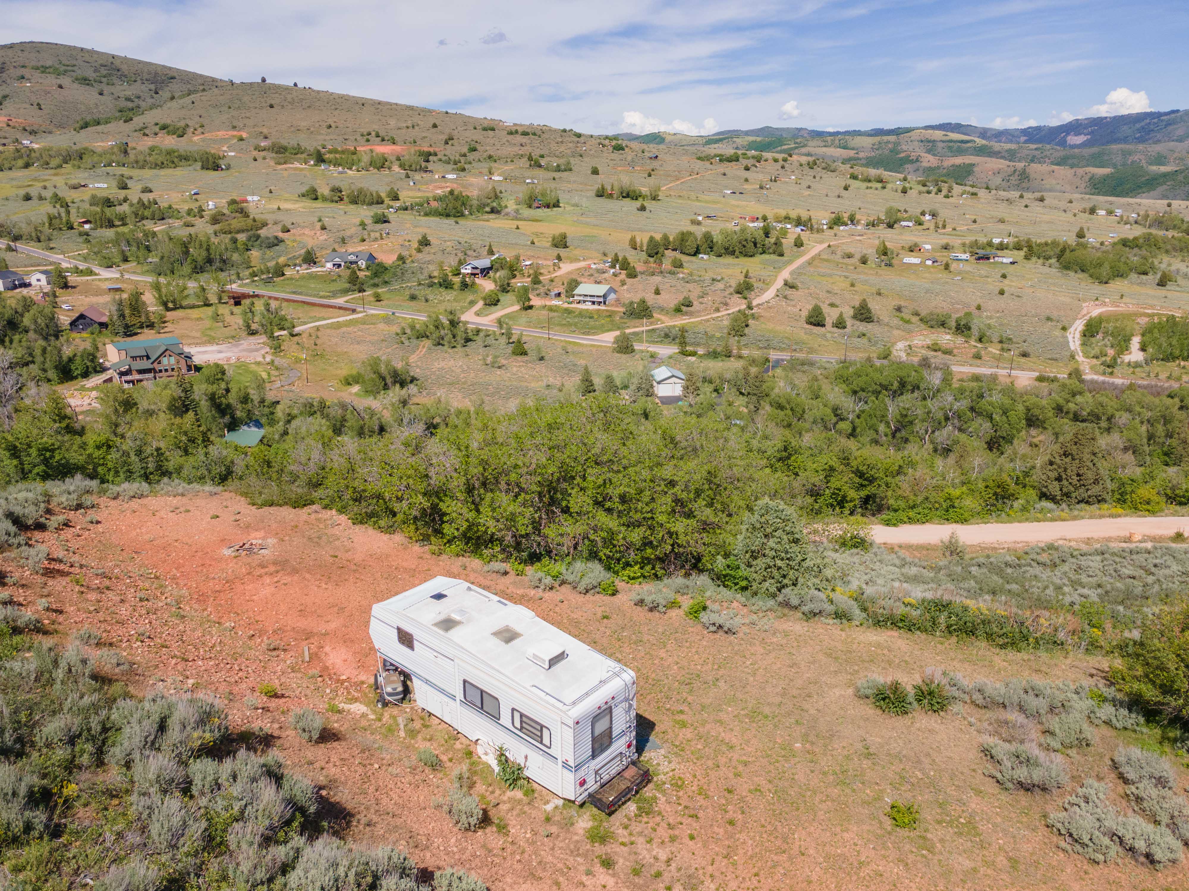 Expansive undeveloped land featuring natural terrain and distant mountainous backdrop