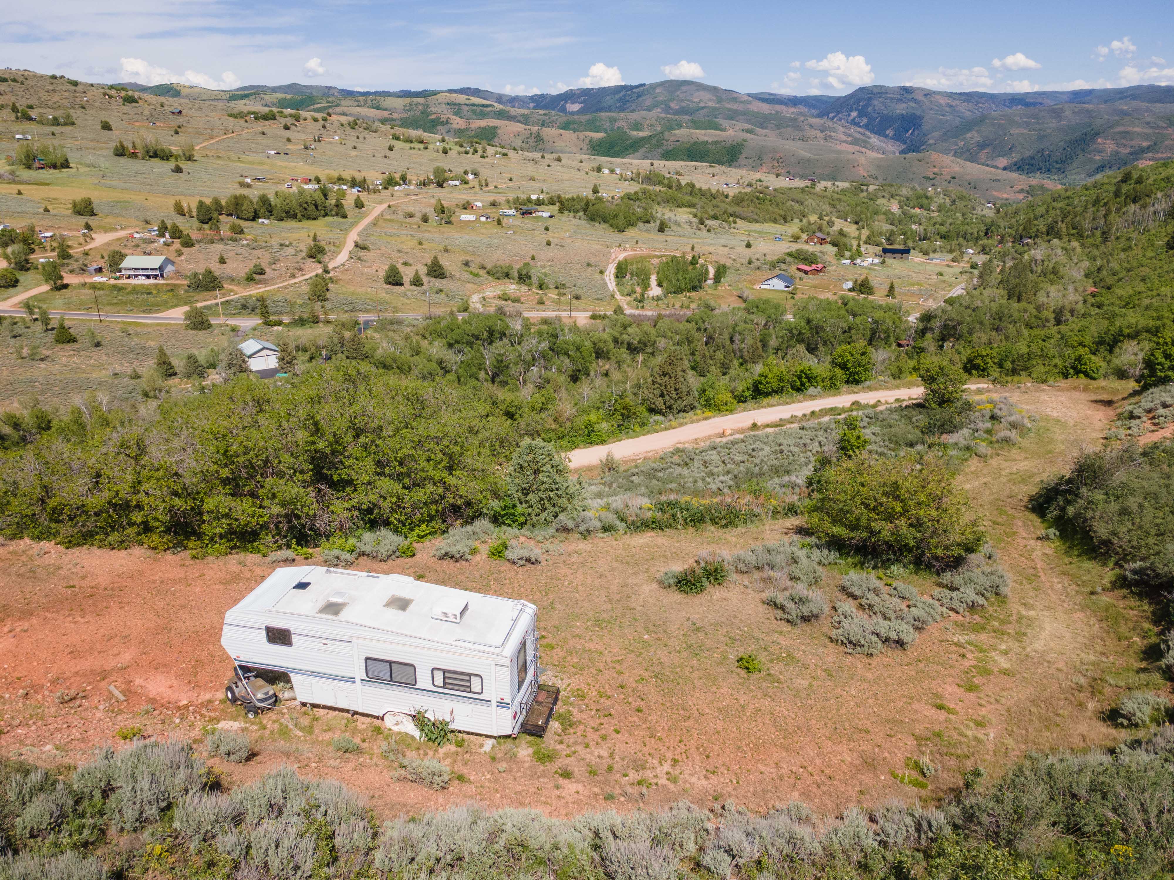 Expansive open land with varied topography, featuring natural vegetation and scattered trees