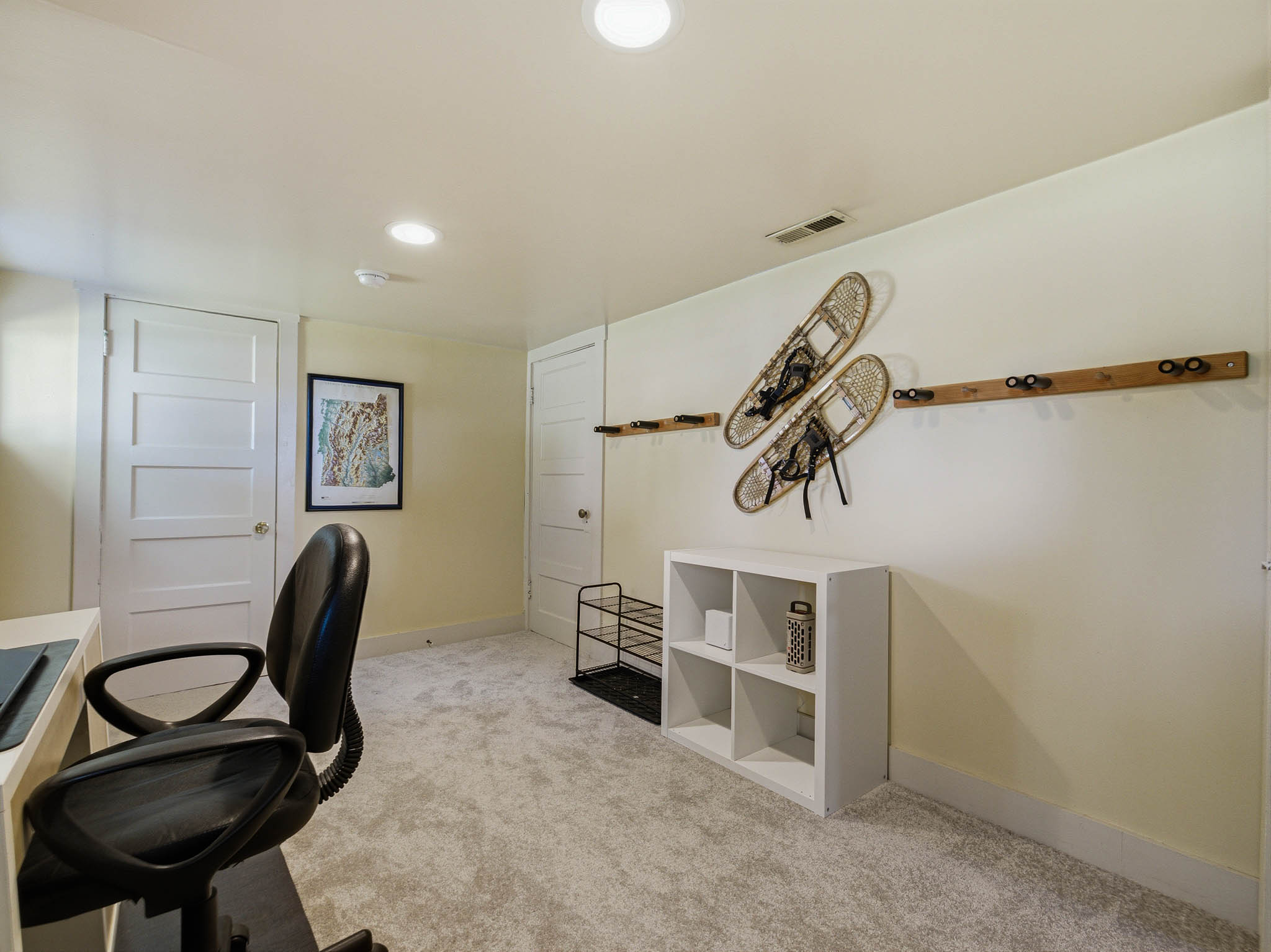 Carpeted room with recessed lighting and four-panel interior doors