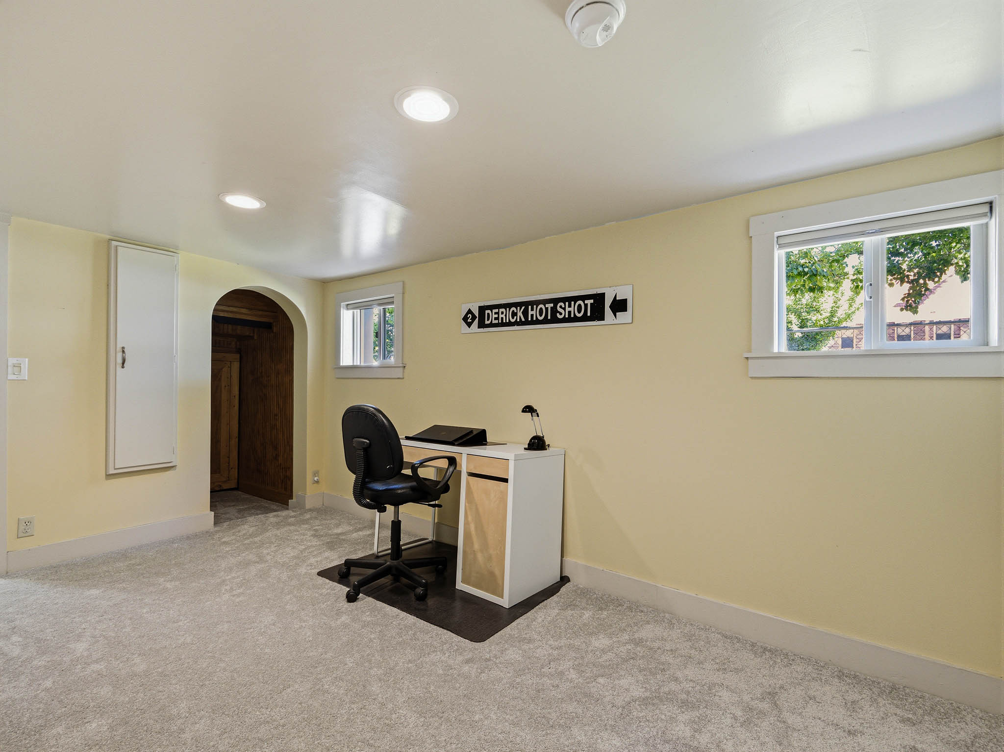 Carpeted interior space with recessed lighting and a built-in wall cabinet