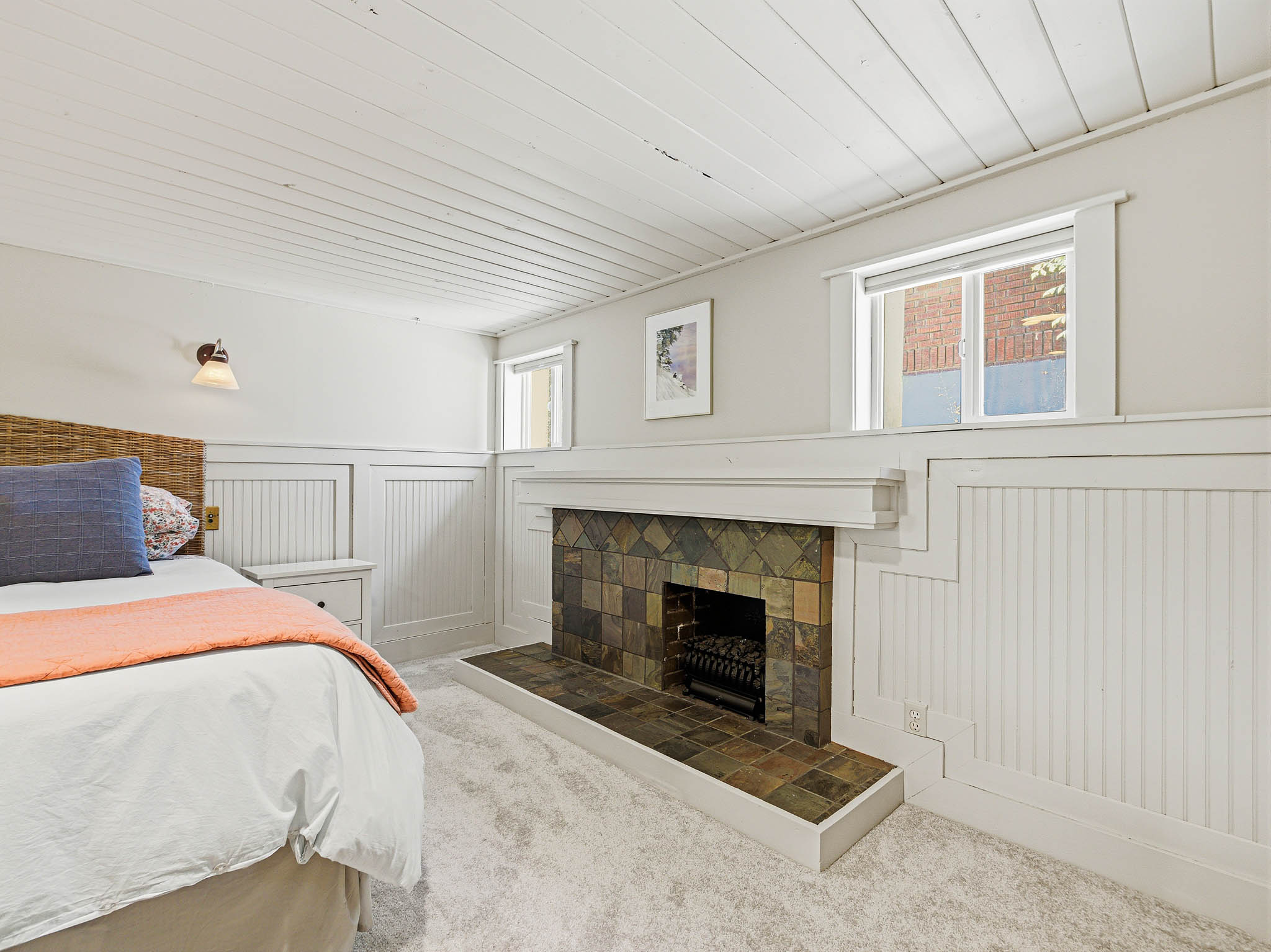 Fireplace featuring a tiled surround and hearth, white mantel, and integrated firebox