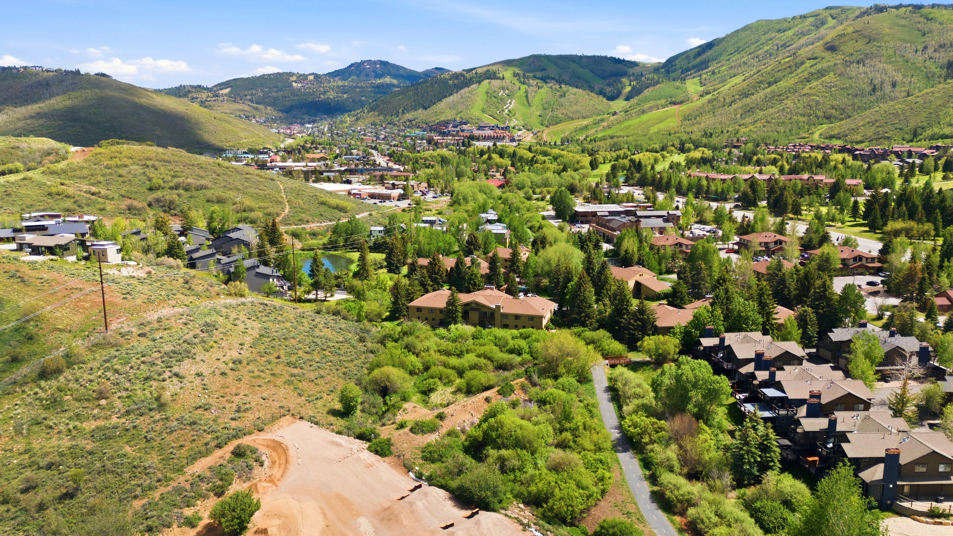 Expansive mountain landscape featuring residential properties and verdant hillsides