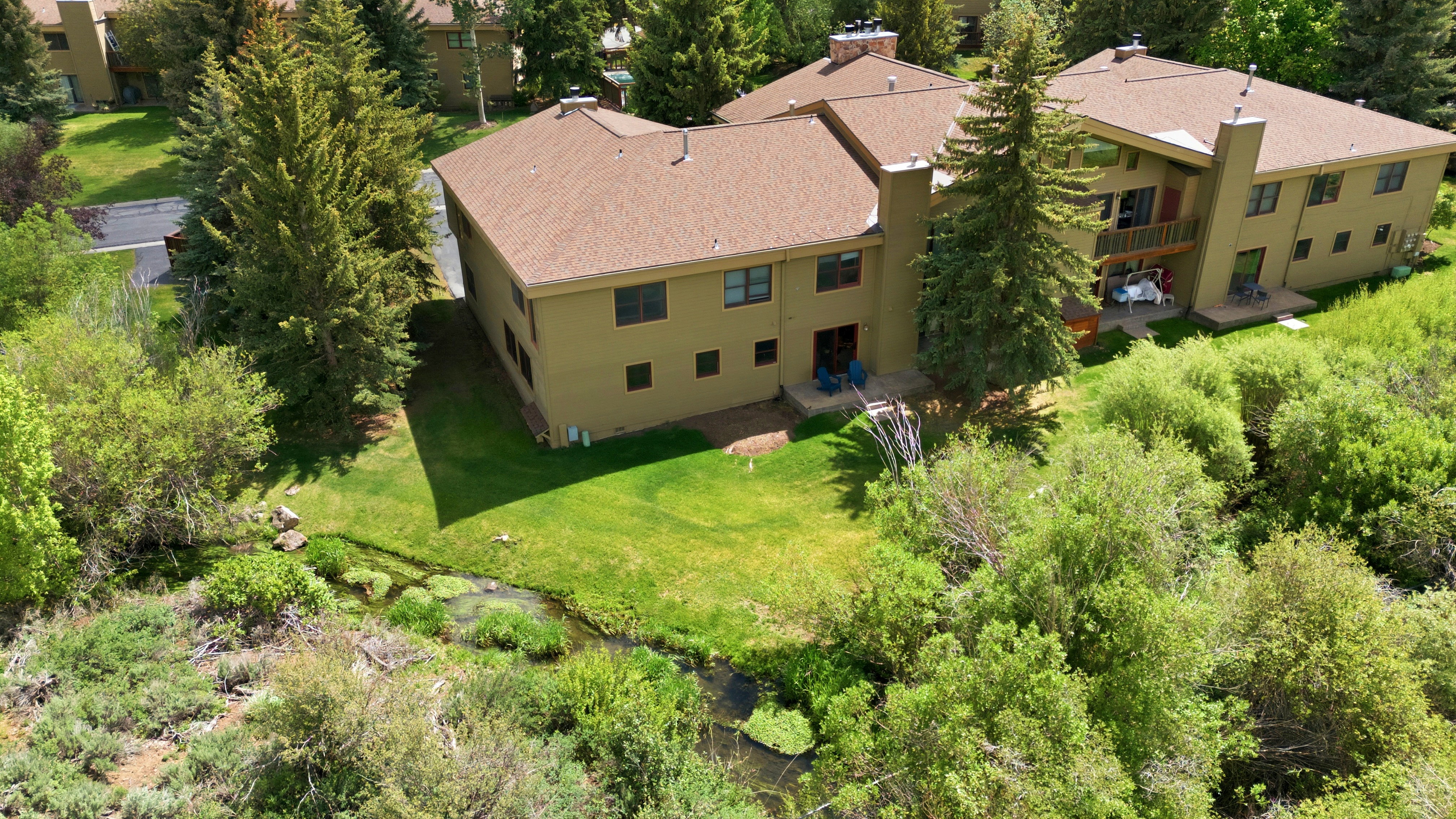 Contemporary multi-level residence featuring a stucco exterior and a shingled roof