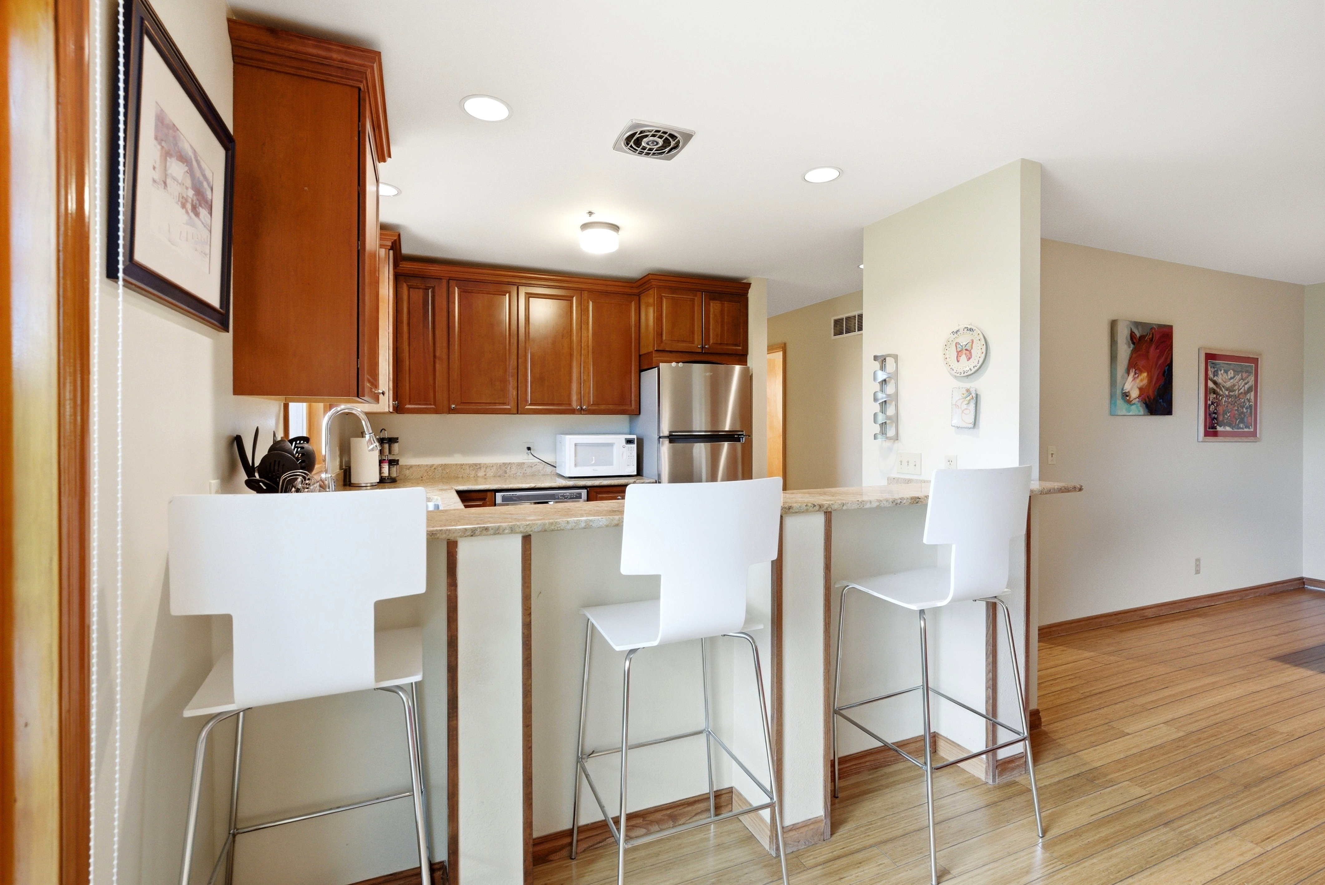 Kitchen featuring wood cabinetry, light-toned countertops, and stainless steel appliances
