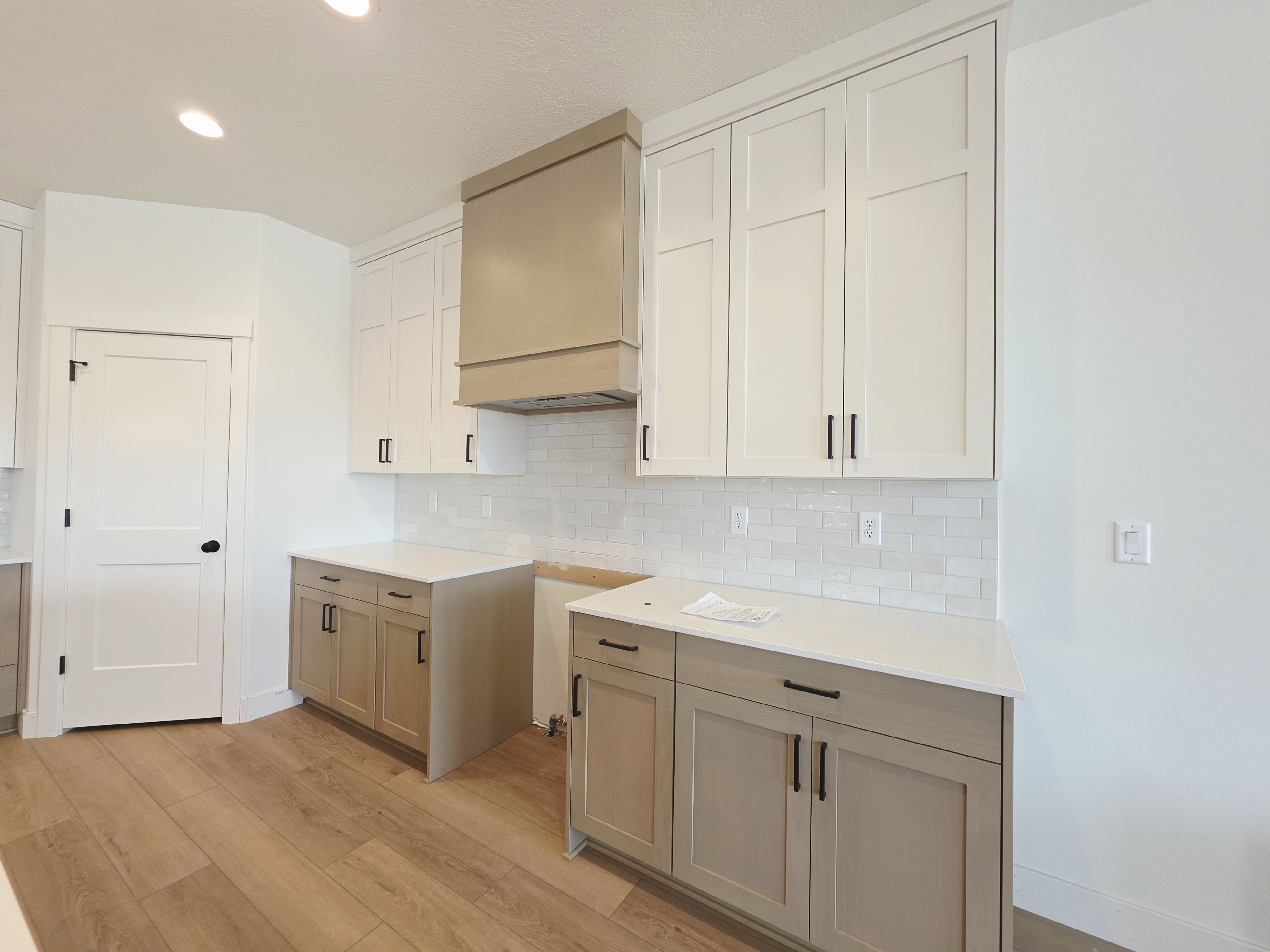 Modern kitchen featuring light wood-finish flooring and recessed lighting