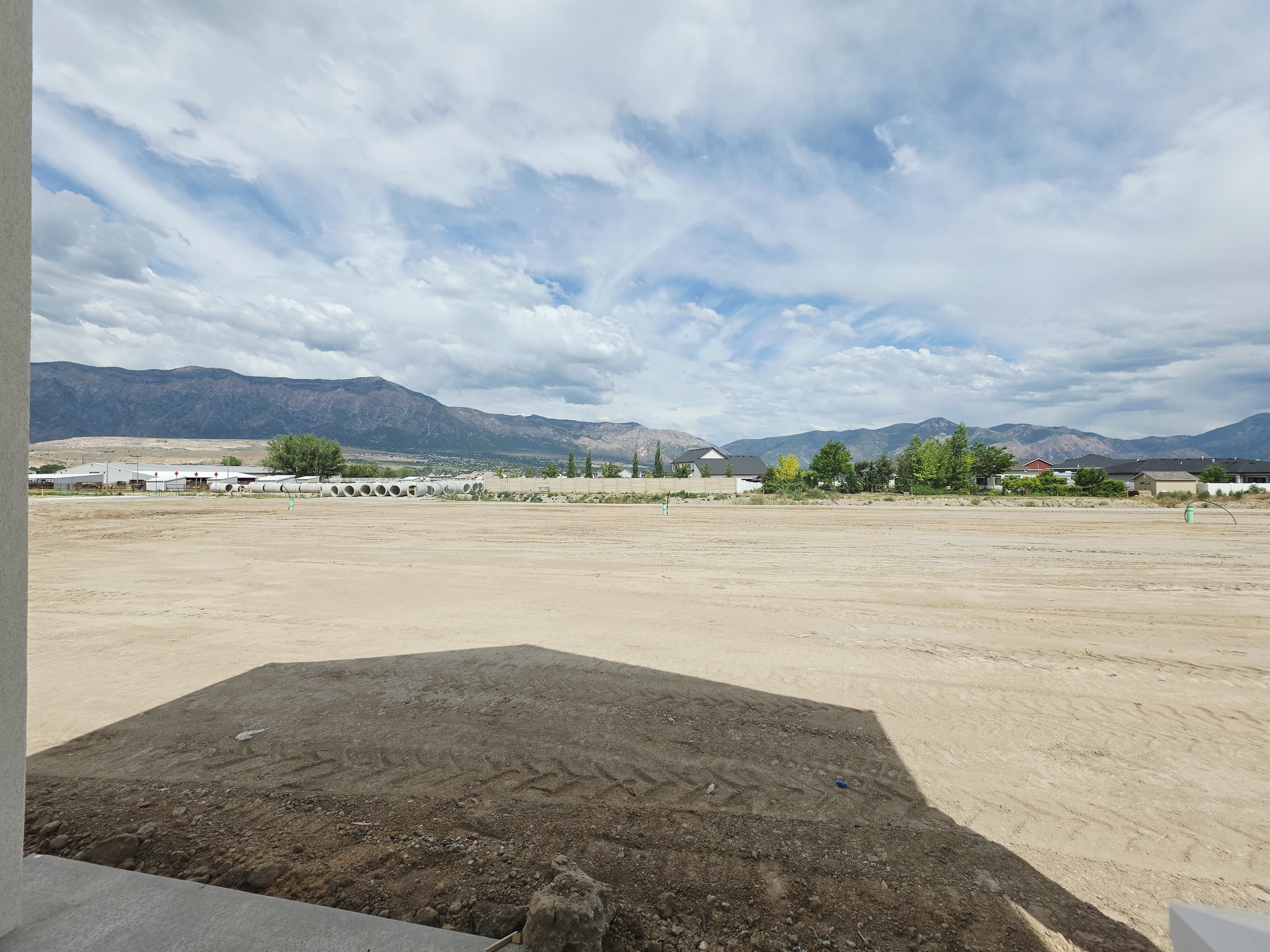 Expansive, undeveloped land parcel with mountain backdrop