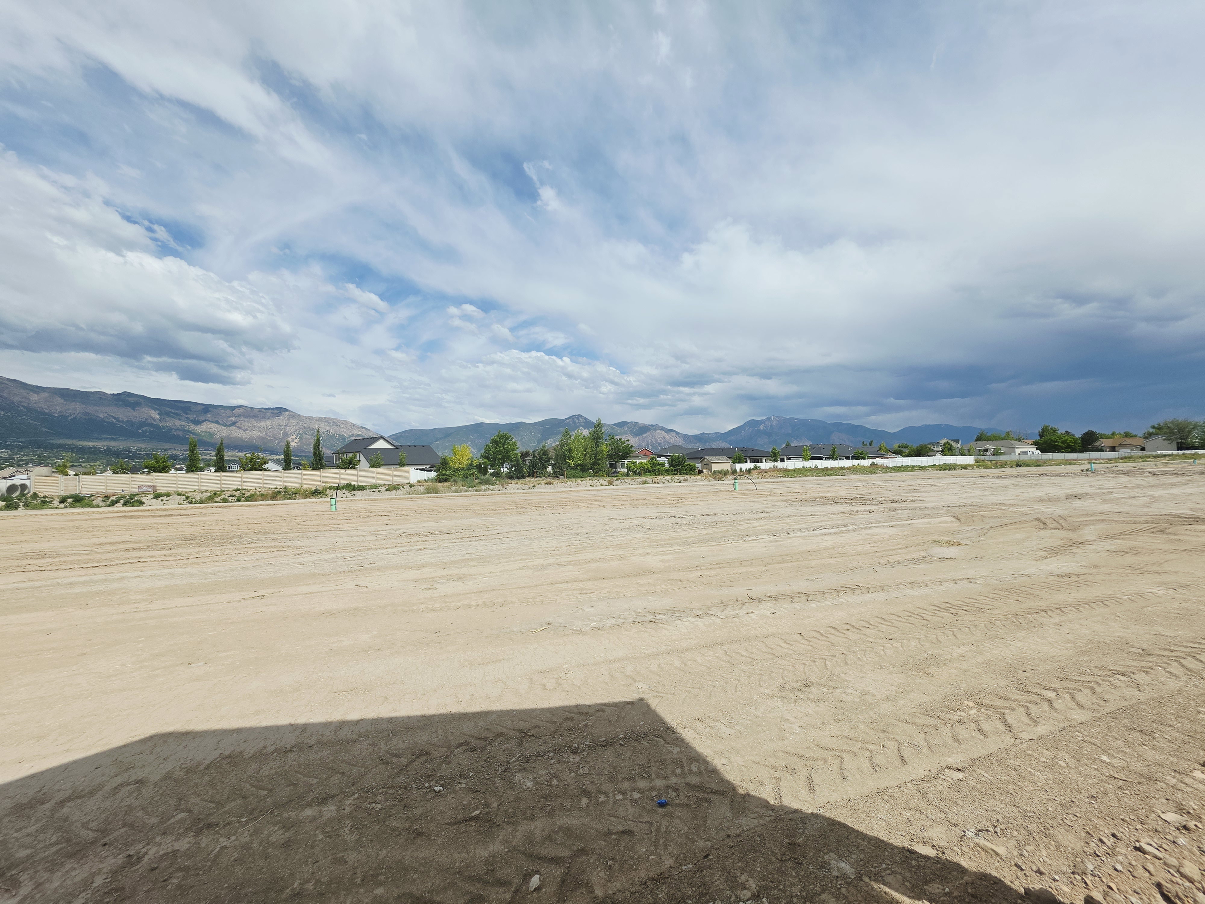 Cleared lot featuring a level, expansive buildable area with visible mountain scenery in the background