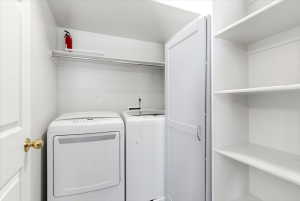 Dedicated laundry area featuring a shelf, hanging rod, and integrated shelving