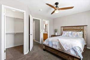 Bedroom featuring neutral wall paint, textured carpet, and a modern ceiling fan with integrated lighting