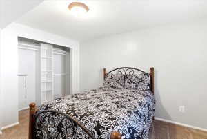 Recessed closet featuring white shelving and dual hanging rods