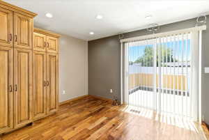 Rich wood-finish flooring complements the built-in cabinetry with dark hardware