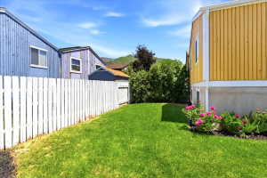 Expansive green lawn bordered by a white picket fence