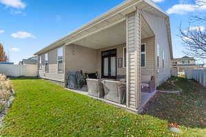 Covered patio with durable concrete flooring, offering direct access to the interior via double glass doors
