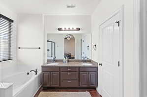 Dual vanity with stone countertop and dark wood cabinetry