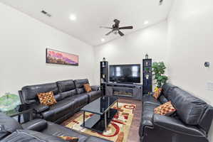 Spacious living area featuring a vaulted ceiling with recessed lighting and a ceiling fan