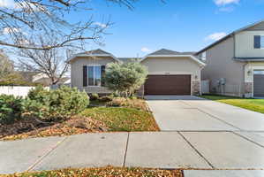 Single-story stucco exterior featuring a two-car garage with a wood-finish door
