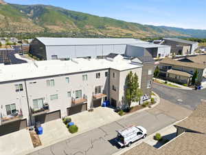 Modern townhome-style residences featuring light-toned exteriors, attached garages, and private balconies