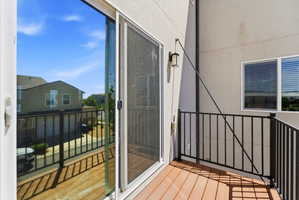 Private balcony featuring composite decking and black metal railing