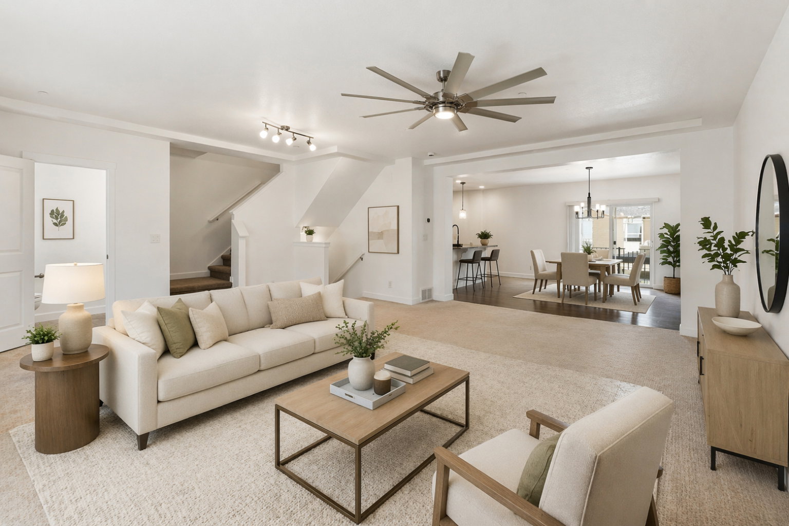 Spacious living area featuring light carpeting, a contemporary ceiling fan, and recessed lighting