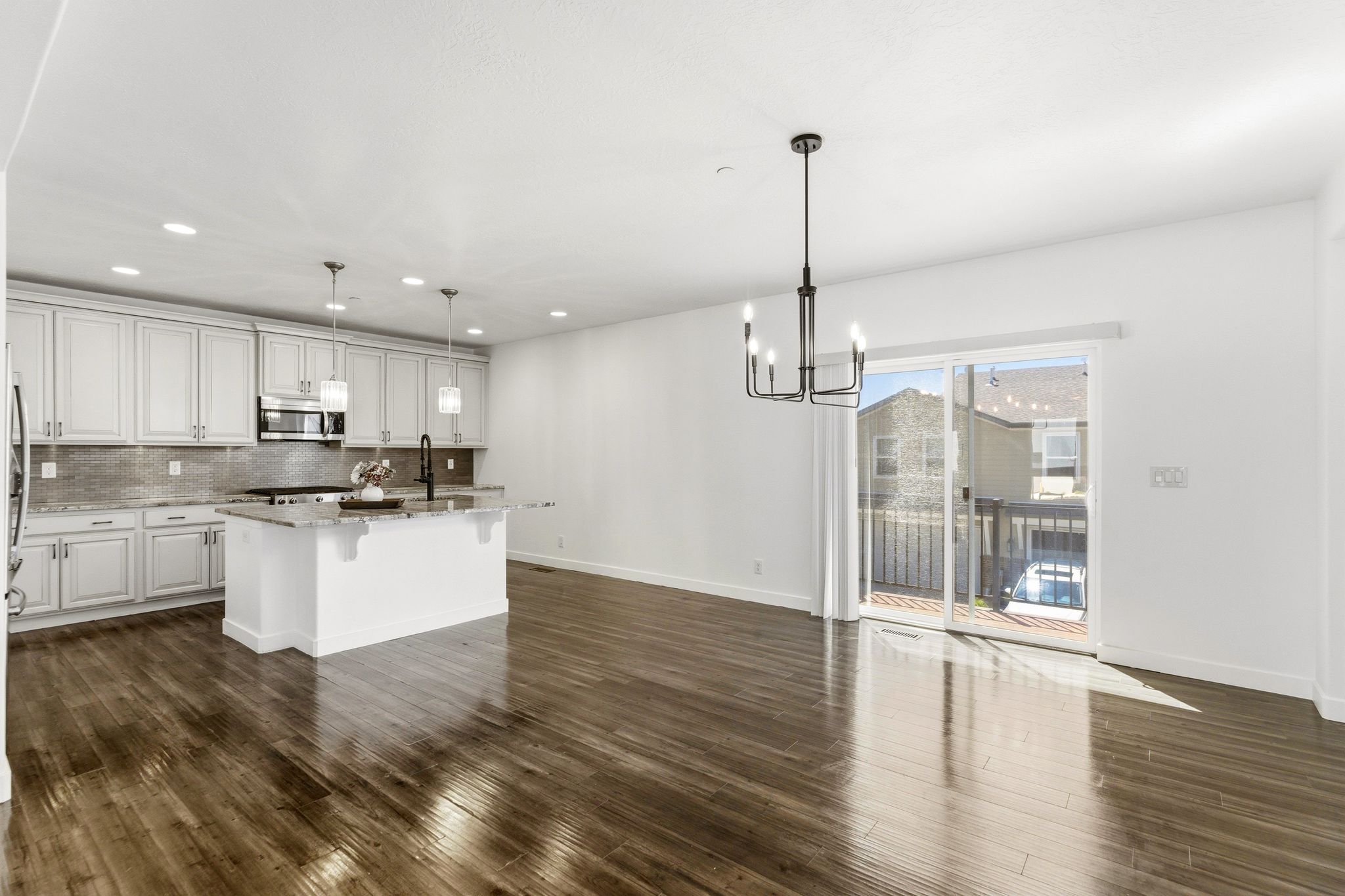 Open-concept living space with wood-finish flooring