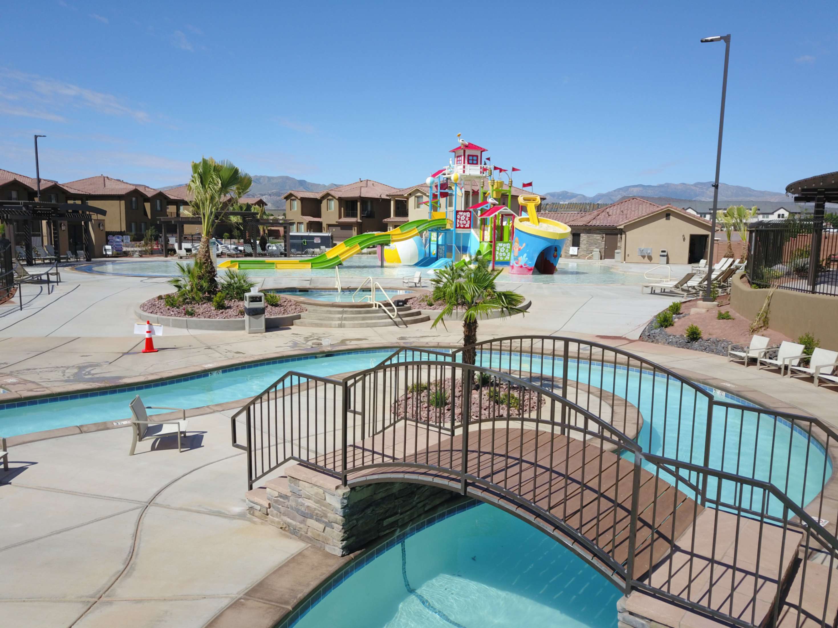 Resort-style aquatic amenity featuring a lazy river, water play structure, and multiple swimming areas