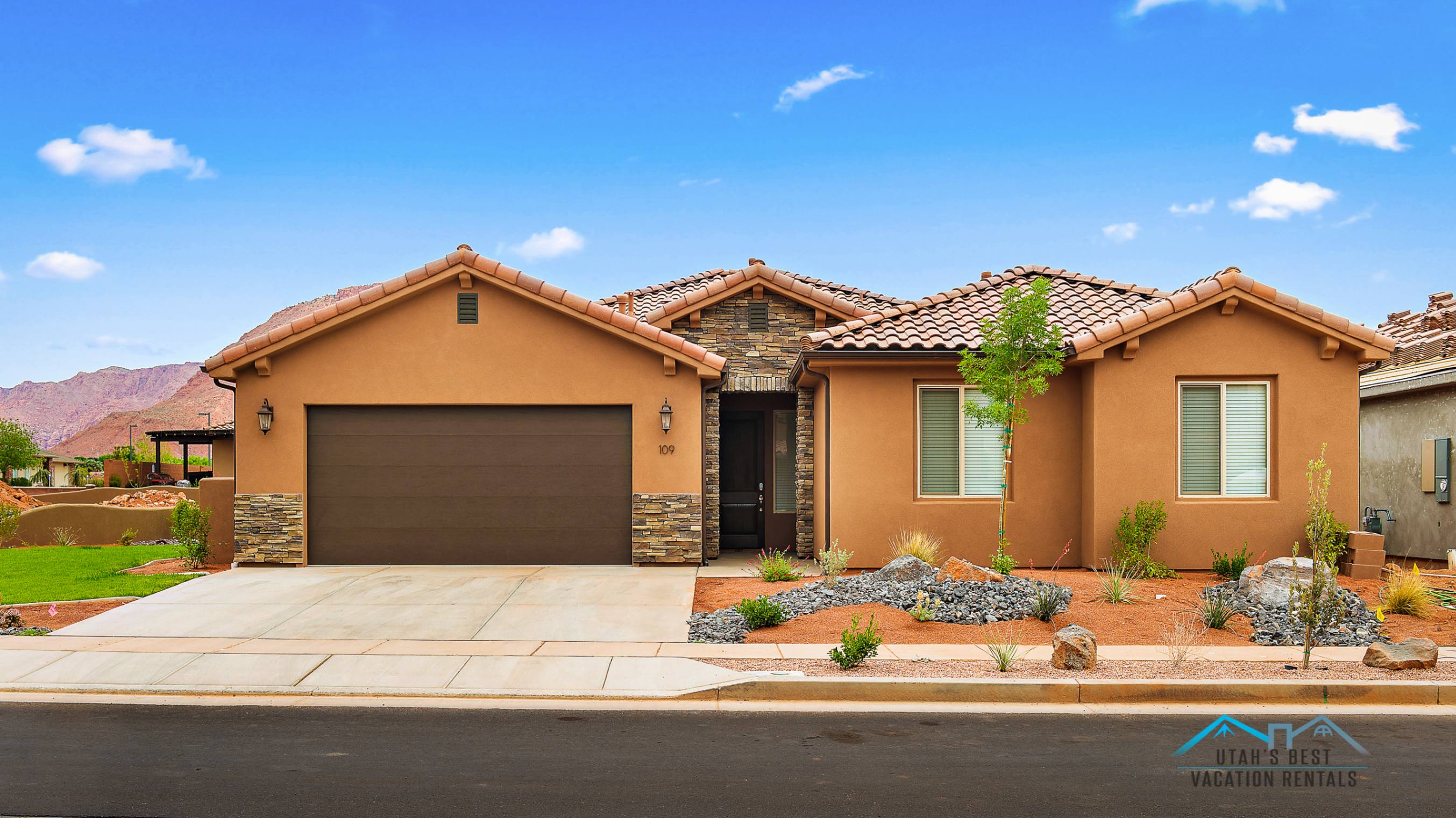 Southwestern style residence featuring a terracotta tile roof and stucco exterior