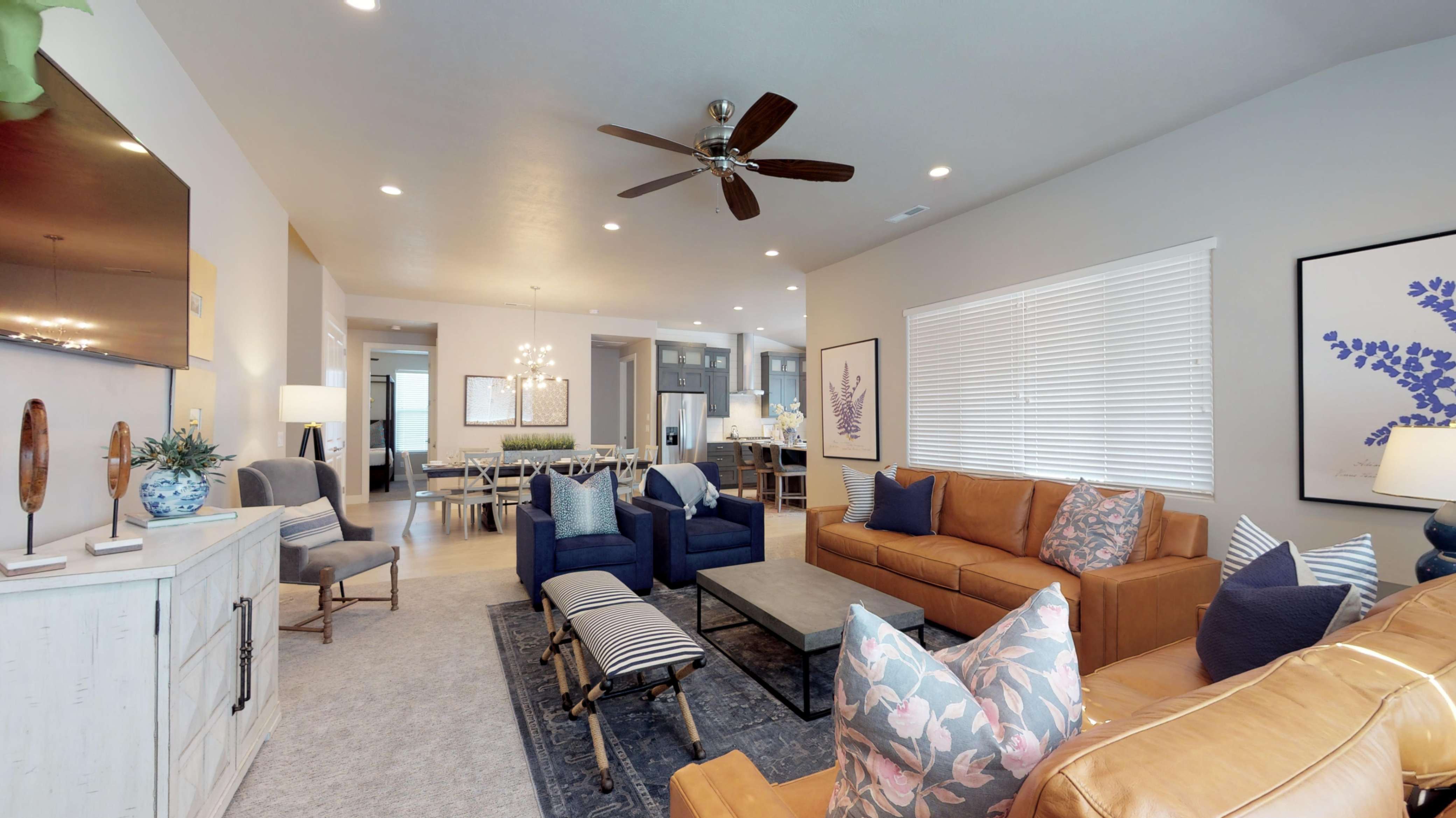 Open-concept living area with recessed lighting and a ceiling fan