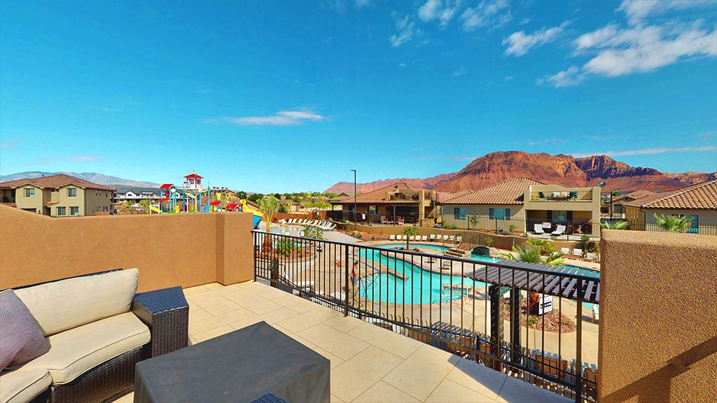 Rooftop patio with tile flooring and a stucco perimeter wall