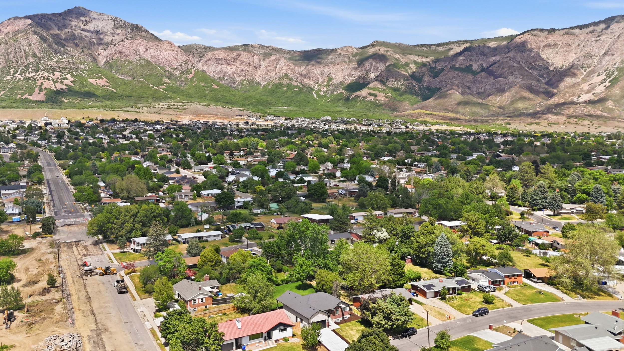Expansive aerial perspective showcasing a residential area with mature tree coverage