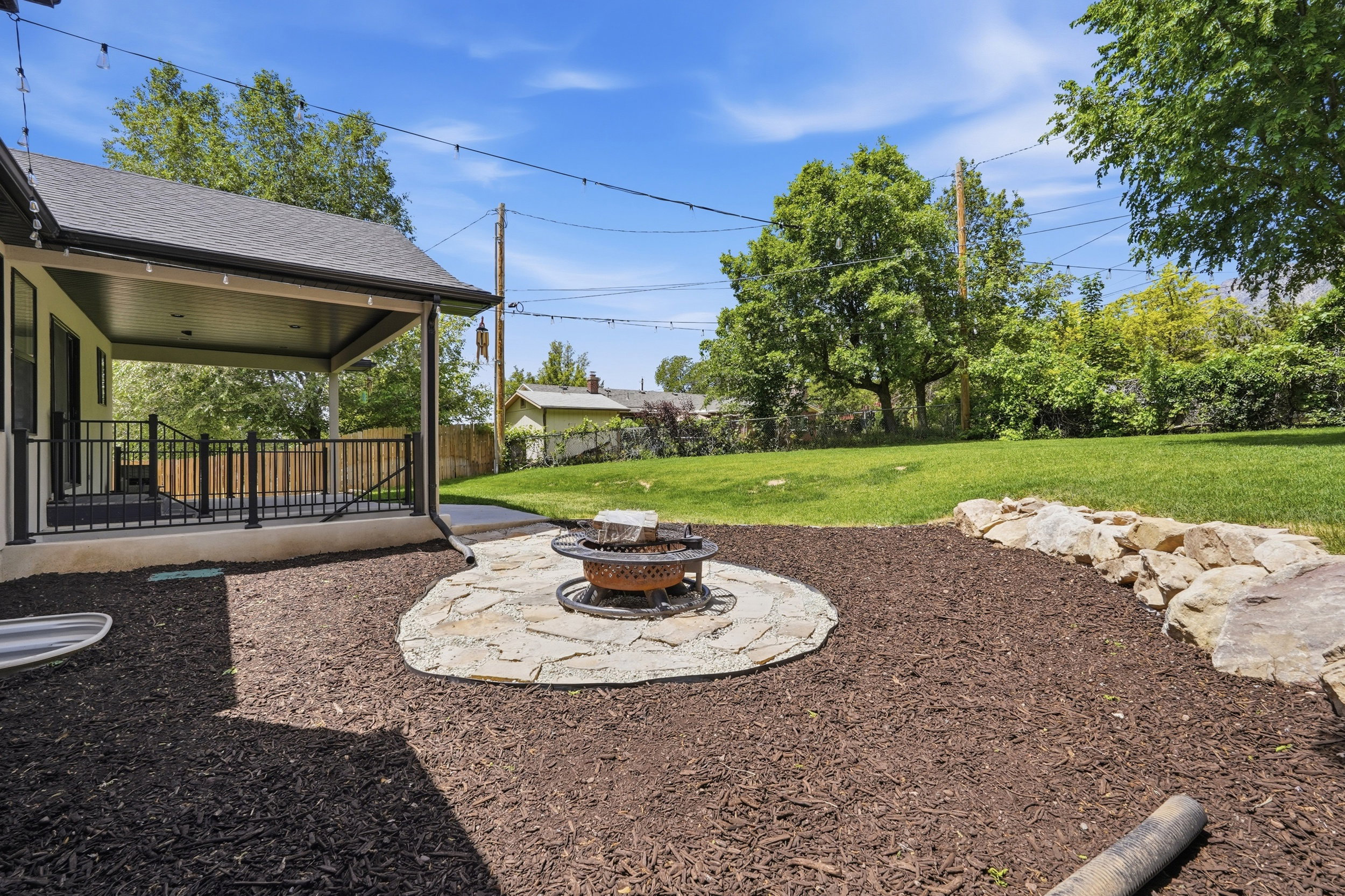 Flagstone fire pit area, and a spacious grass lawn