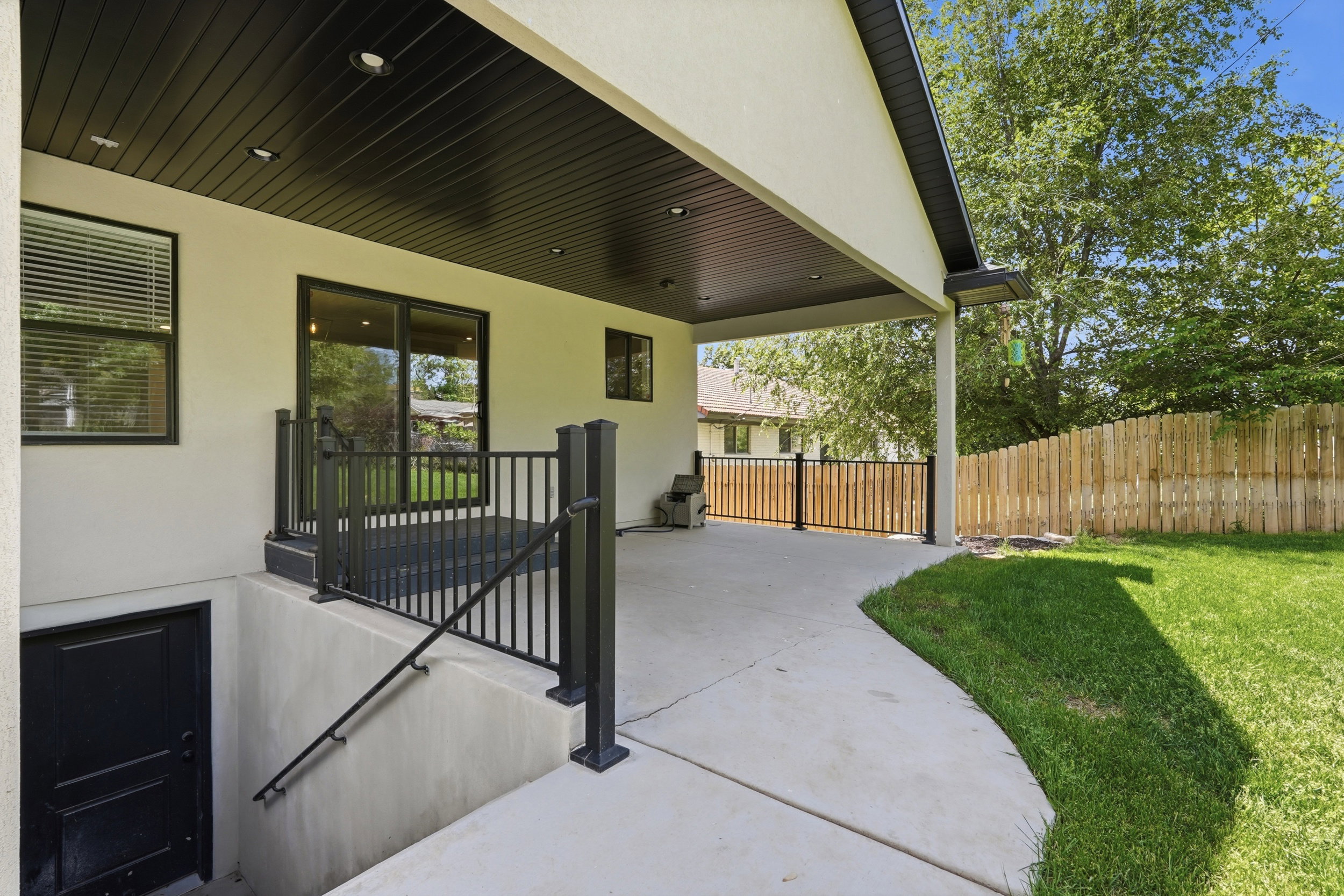 Covered patio with recessed lighting, and basement access entrance