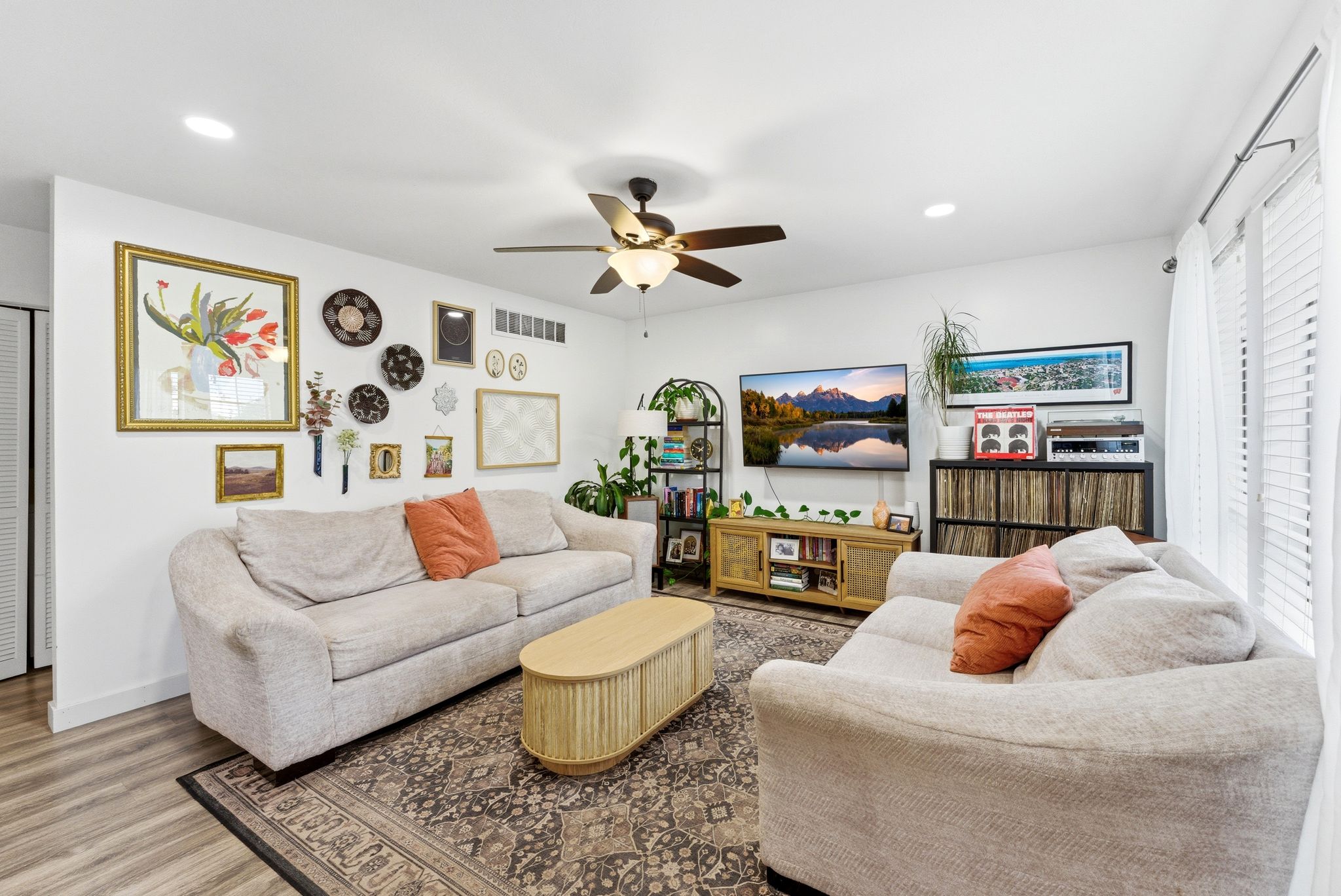 Open-concept living space with wood-finish flooring and recessed lighting