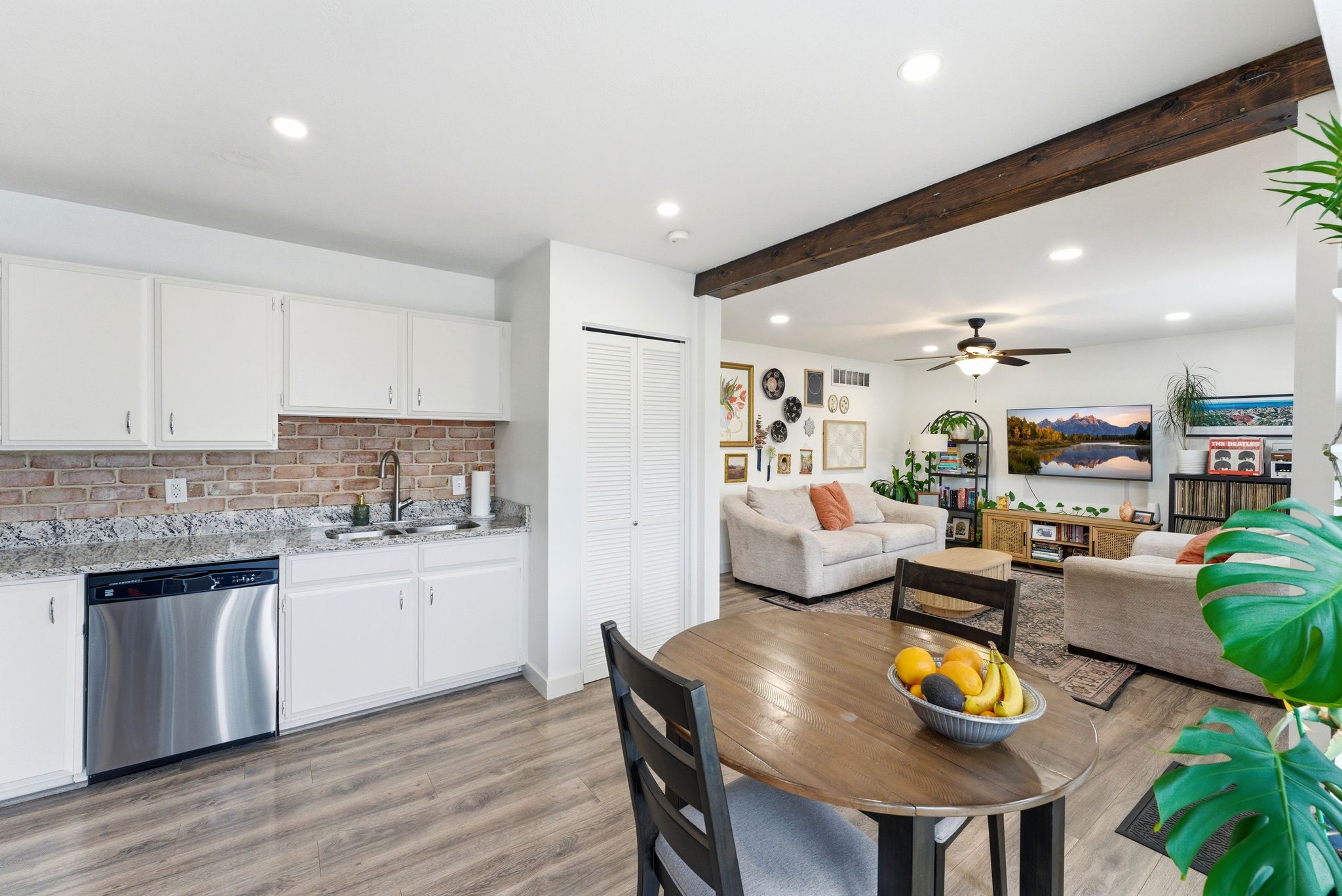 Kitchenette and living area featuring wood-finish flooring