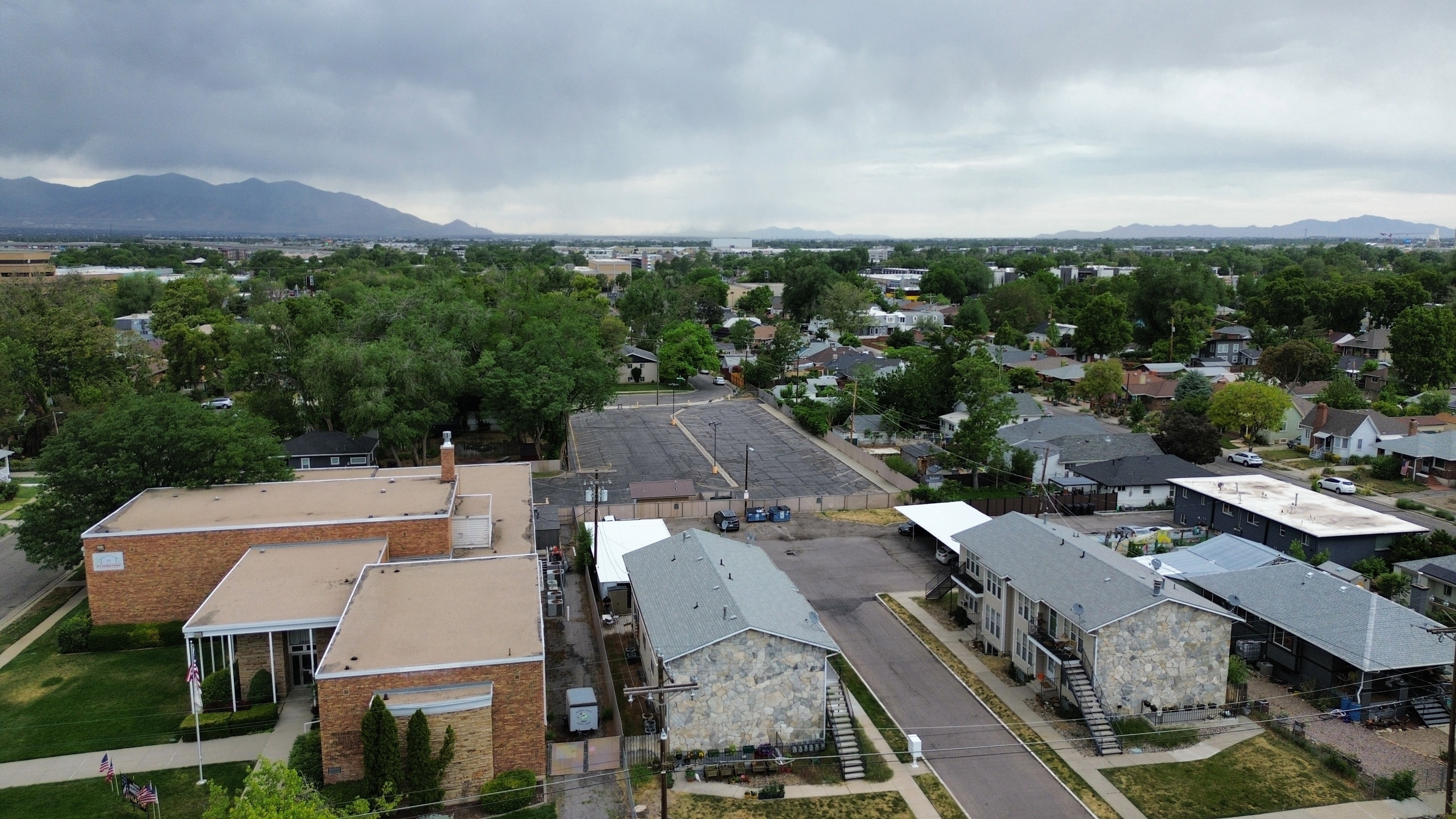 Aerial perspective showcasing multifamily properties and a commercial building