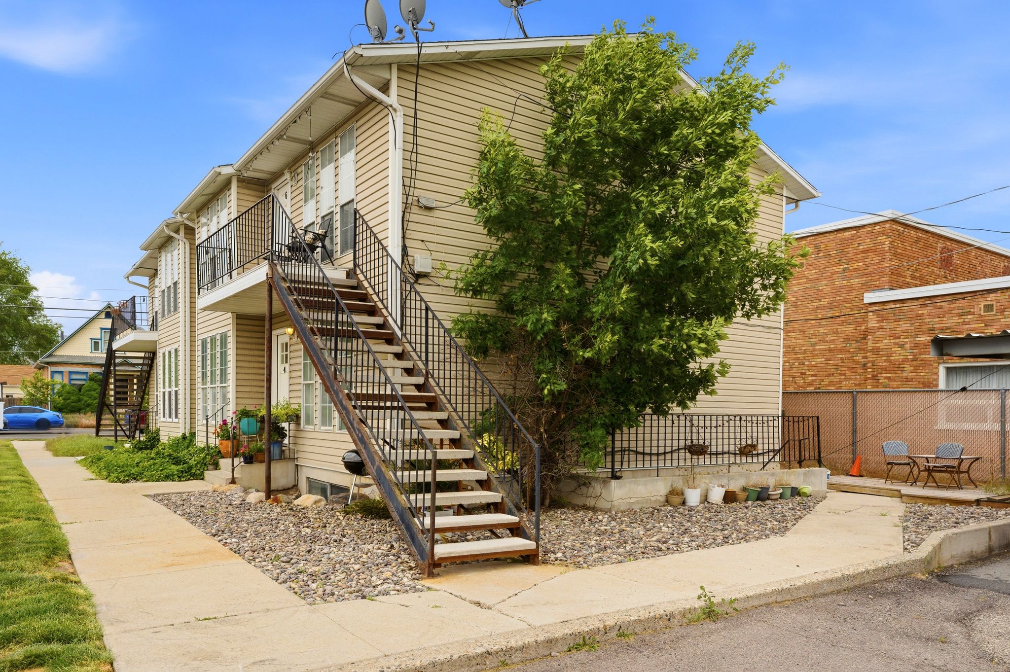 Two-story multi-unit dwelling with horizontal siding and multiple exterior access staircases