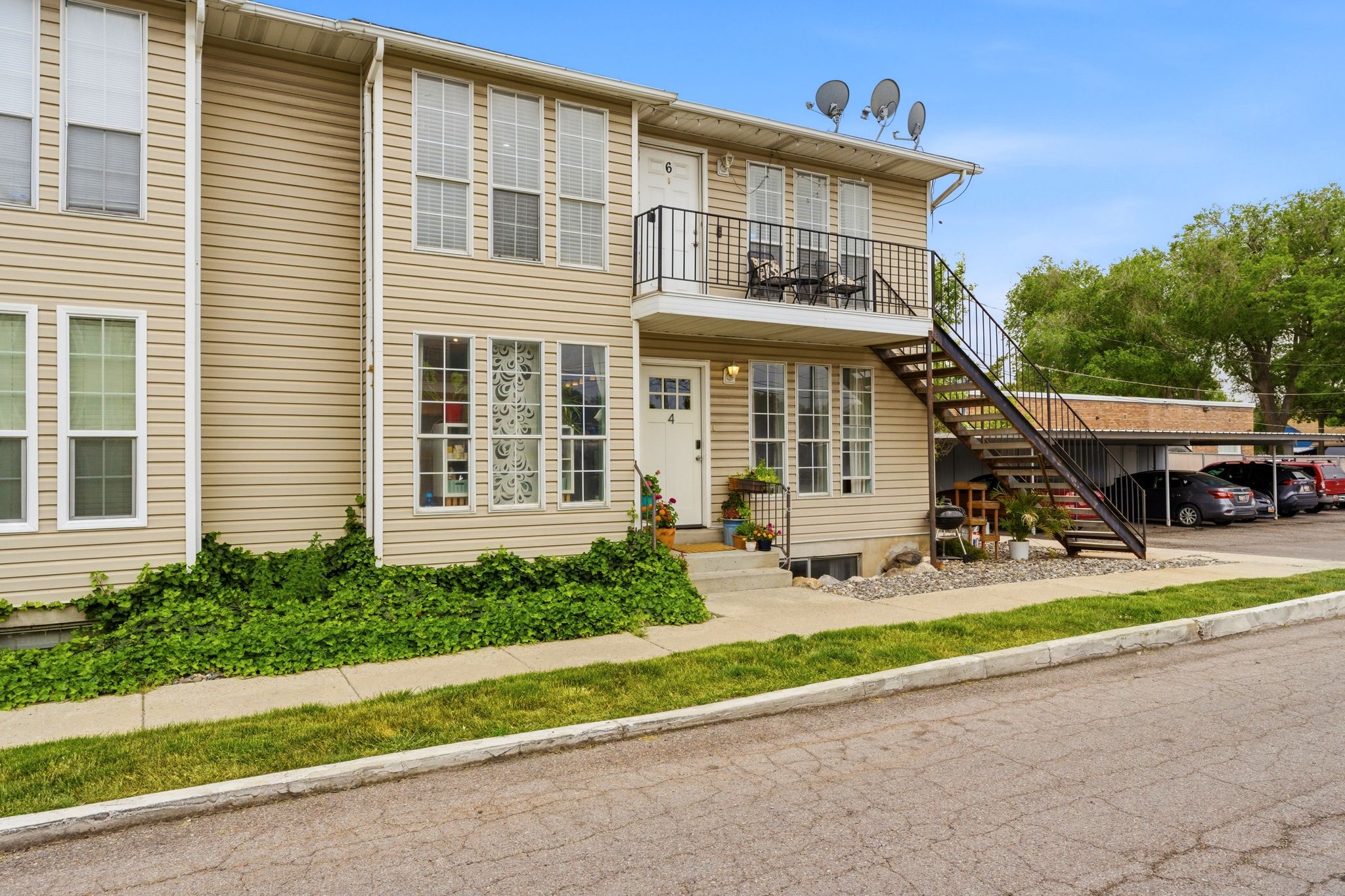 Multi-level building with horizontal vinyl siding and white-framed windows