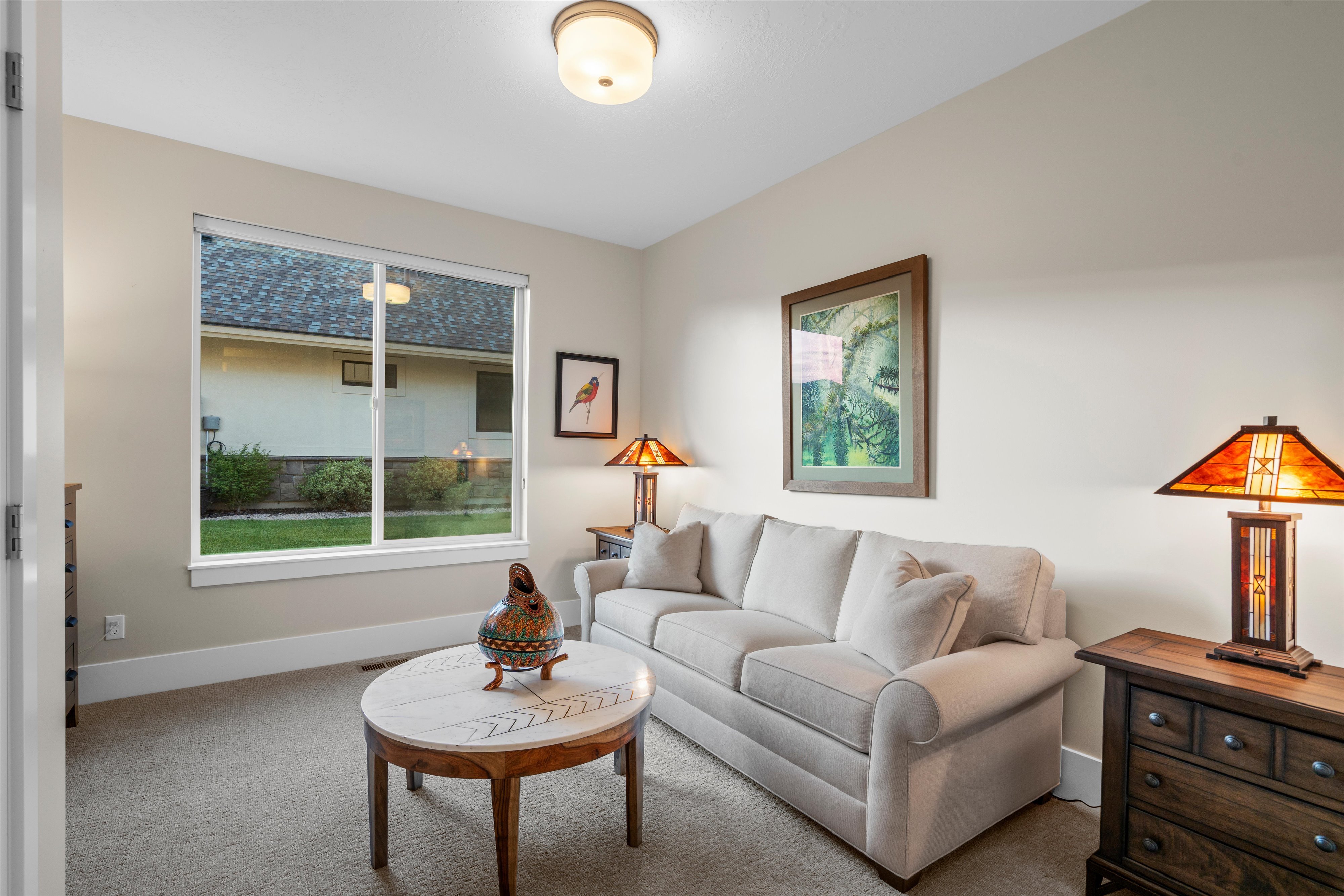 Carpeted room with a large window, neutral wall tones, and recessed lighting