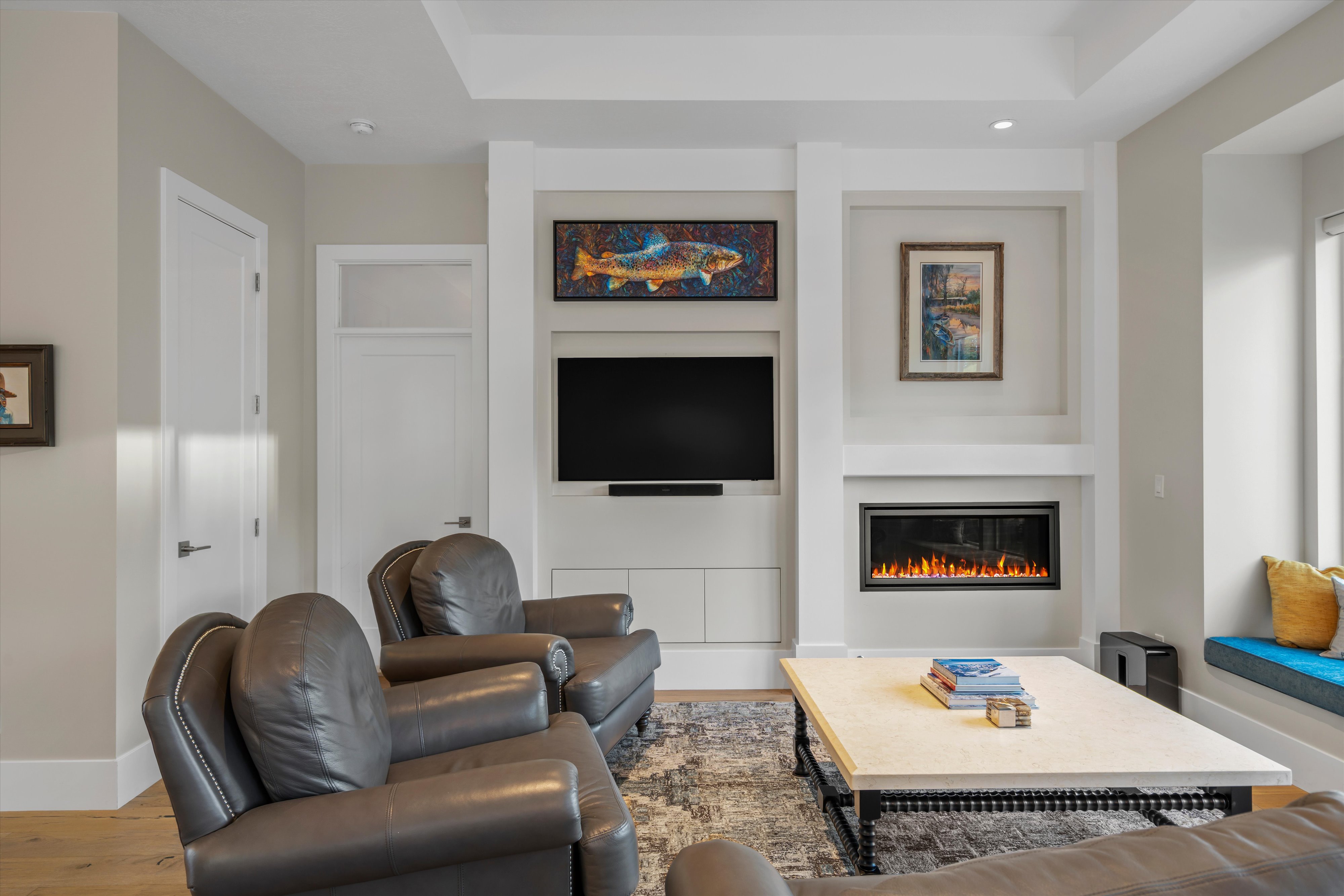 Living area with wood-finish flooring and light-toned walls