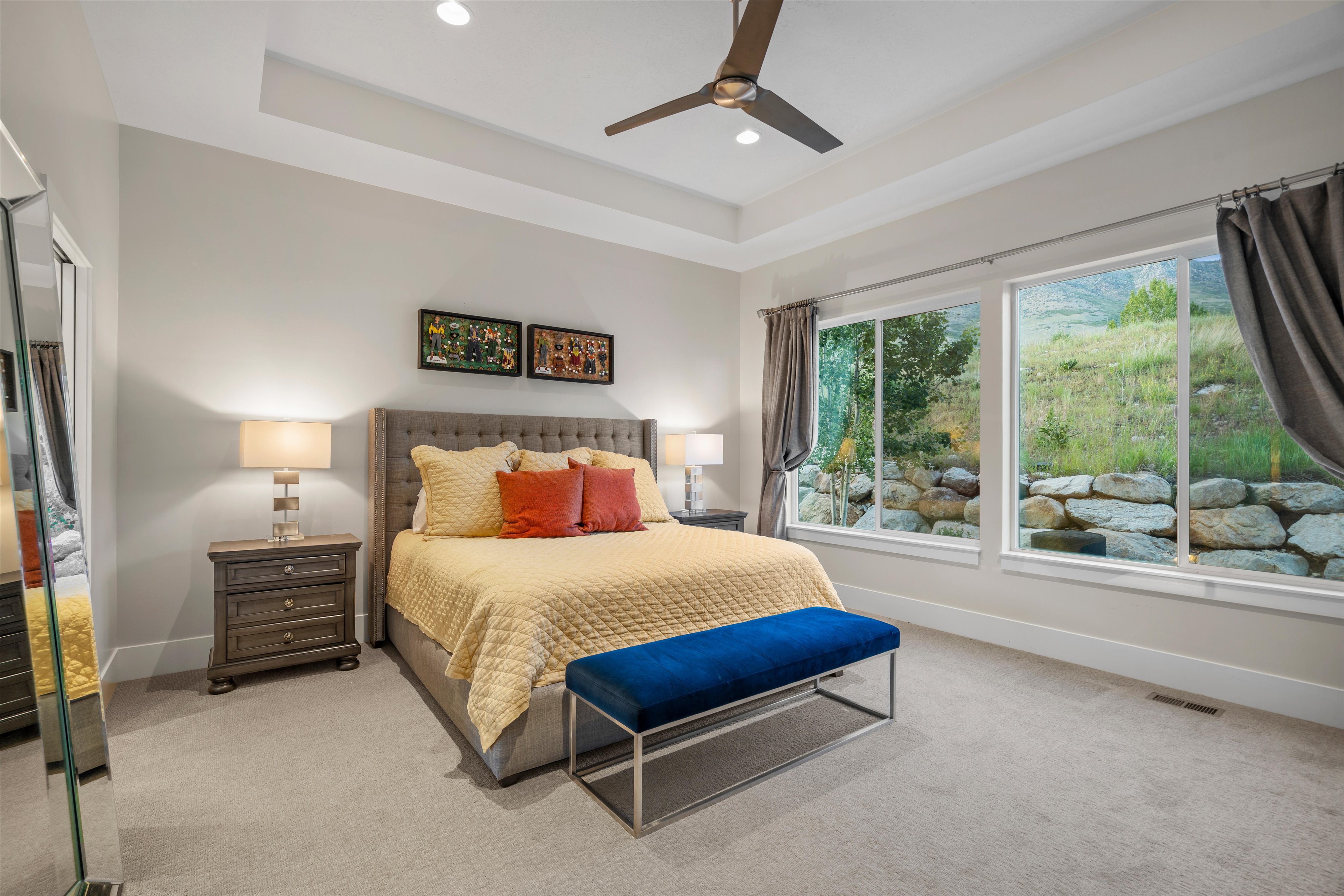 Spacious bedroom featuring large windows, tray ceiling, recessed lighting, and ceiling fan