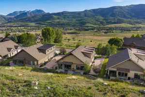 Contemporary mountain home with a distinctive exterior, surrounded by natural landscaping and distant mountain scenery