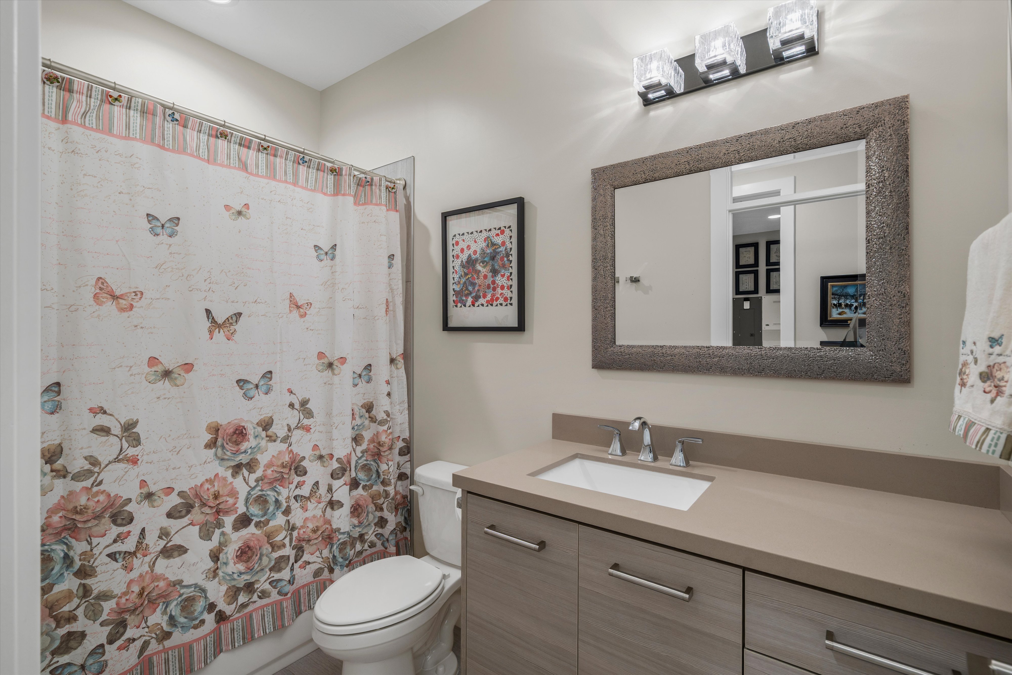 Modern bathroom vanity featuring a rectangular undermount sink and polished chrome faucet