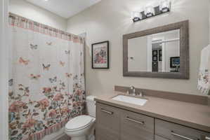 Modern bathroom vanity featuring a rectangular undermount sink and polished chrome faucet